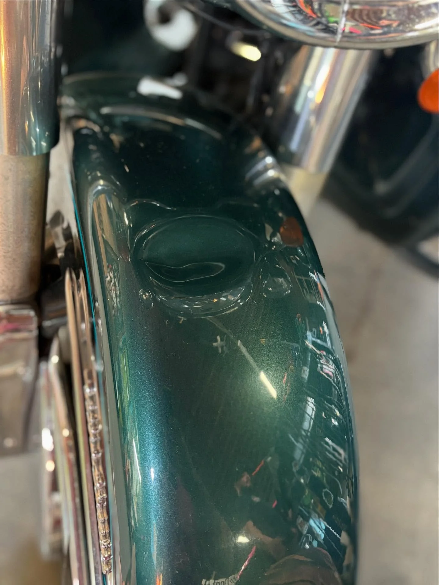 Harley-Davidson front fender — before: dent repaired without removing the fender.