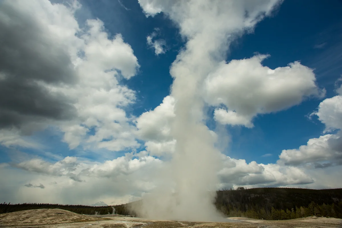 Old Faithful shooting steam into the Sky