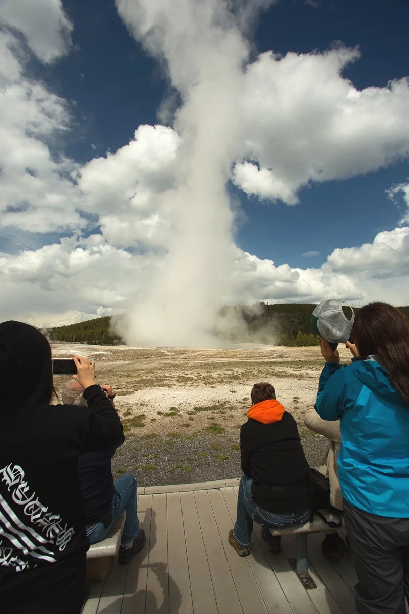 Old Faithful entertaining tourists