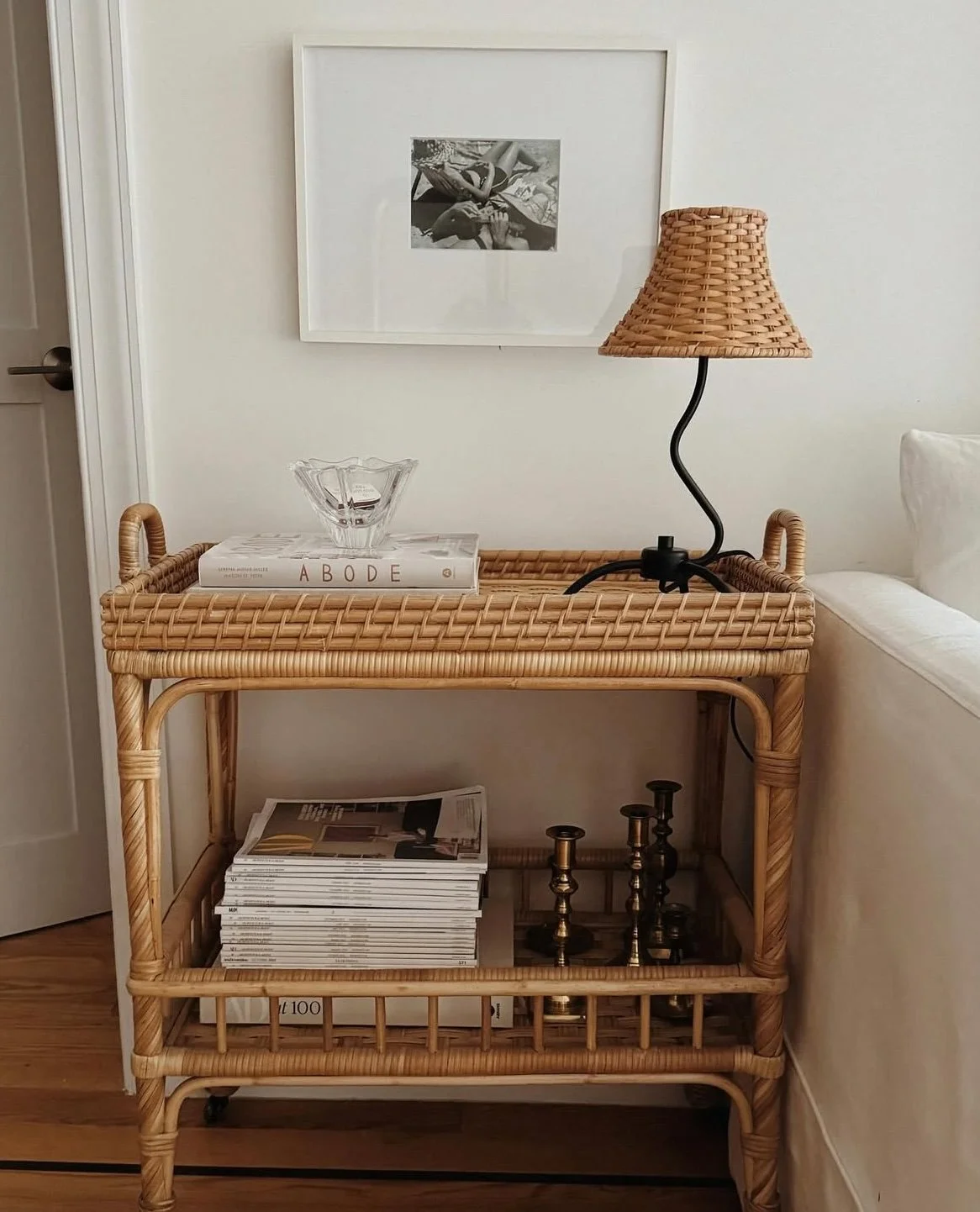 Greenpoint Brooklyn entryway interior design featuring a rattan console, woven table lamp, and layered neutral styling.