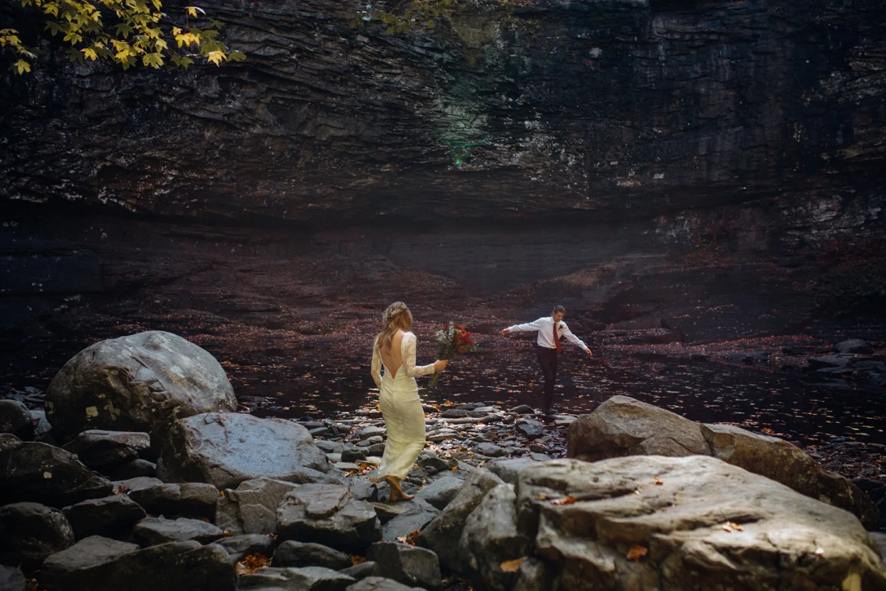 romantic couple playing in cloudland canyon river in fall in georgia