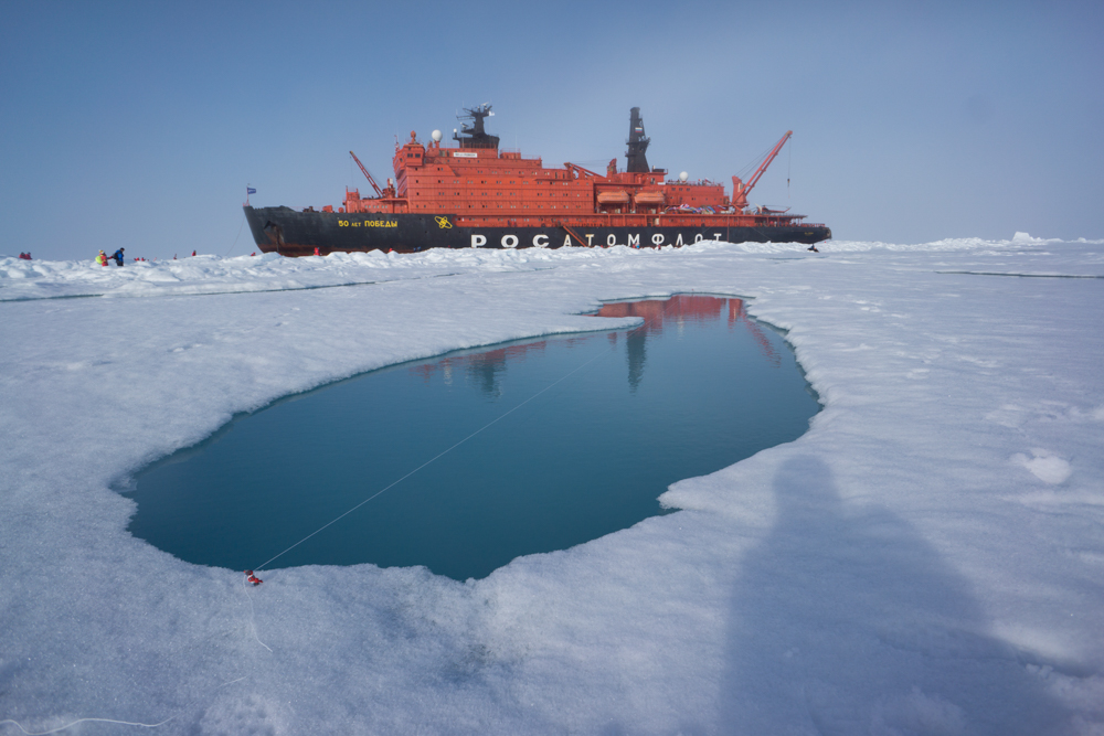 Collecting melt pond data at the North Pole. Here we are measuring the first pond's length and depth profile, as well as its salinity.