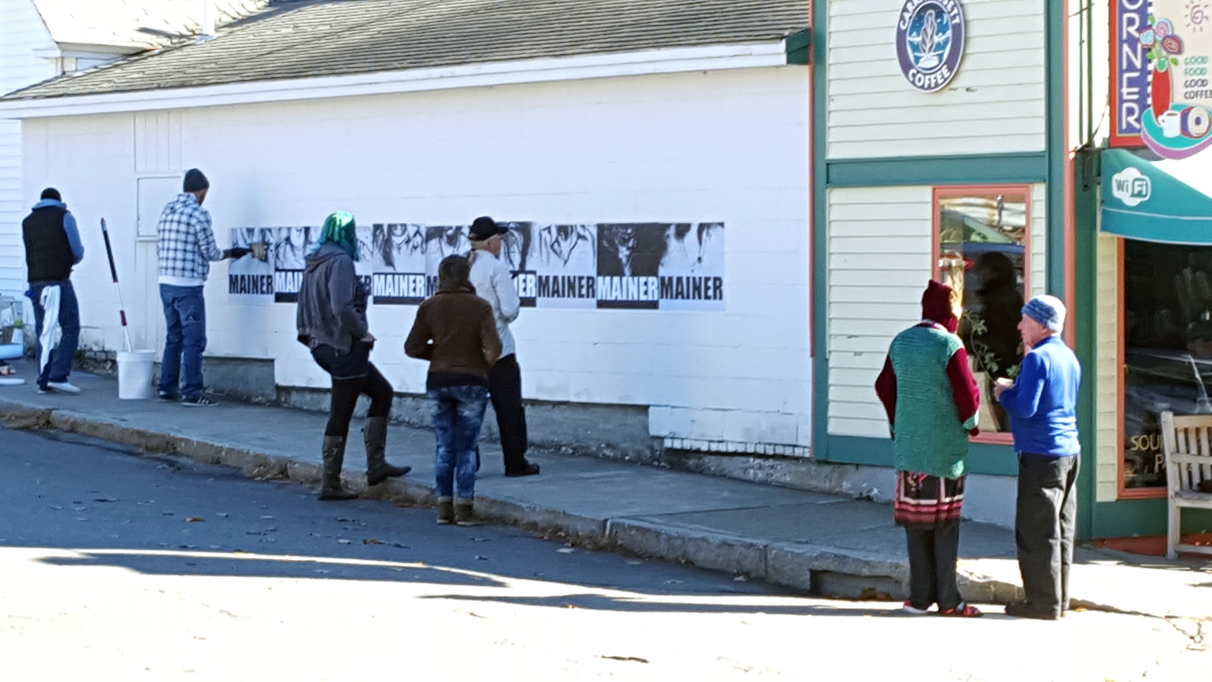  Guest Artist Pigeon installing  Mainers  on the north wall of Java Joe's 