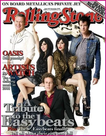 A Rolling Stone magazine cover featuring band members from Oasis and The Beatles, with headlines about music and artists.