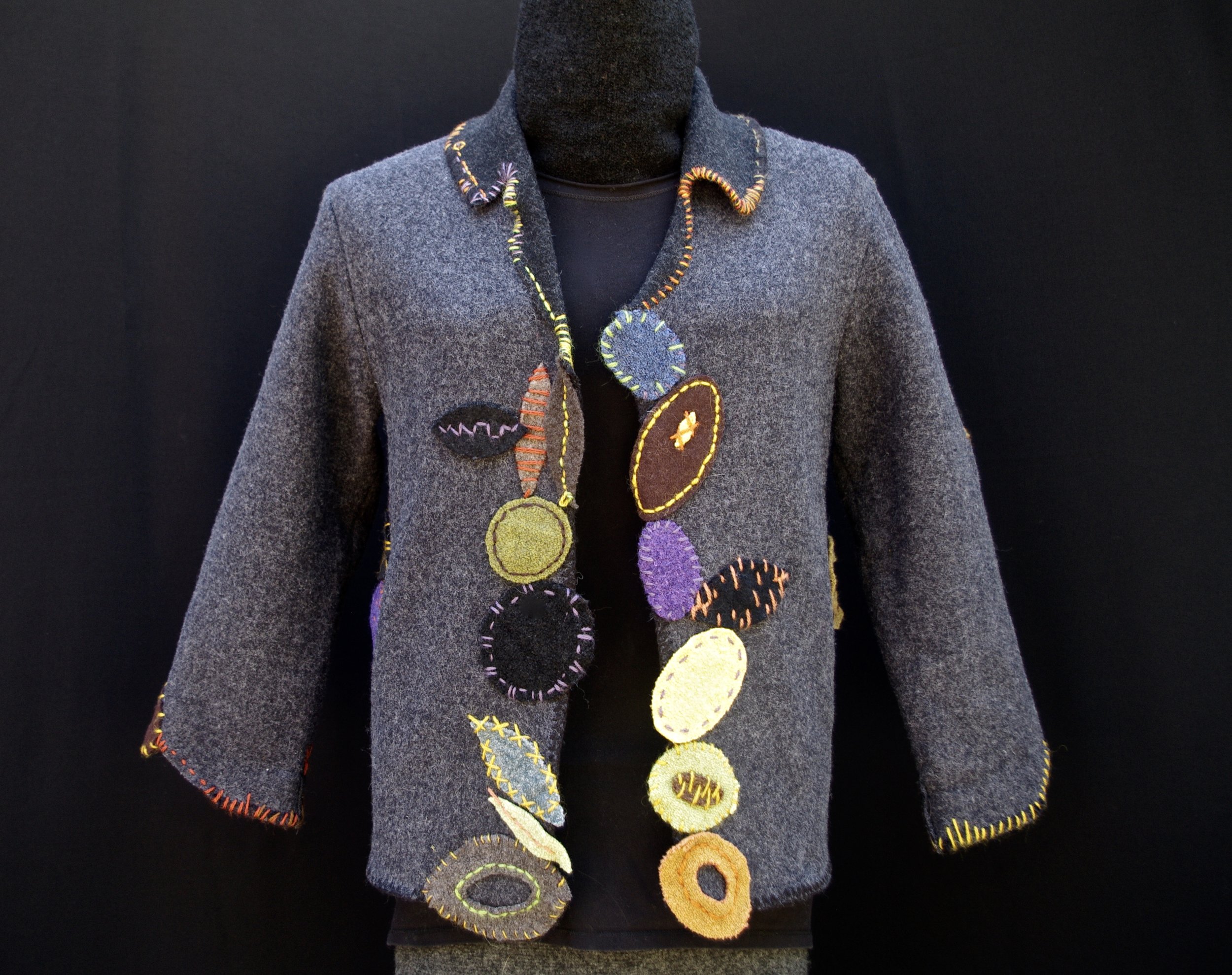 Fitted jacket with hand stitched appliqué.