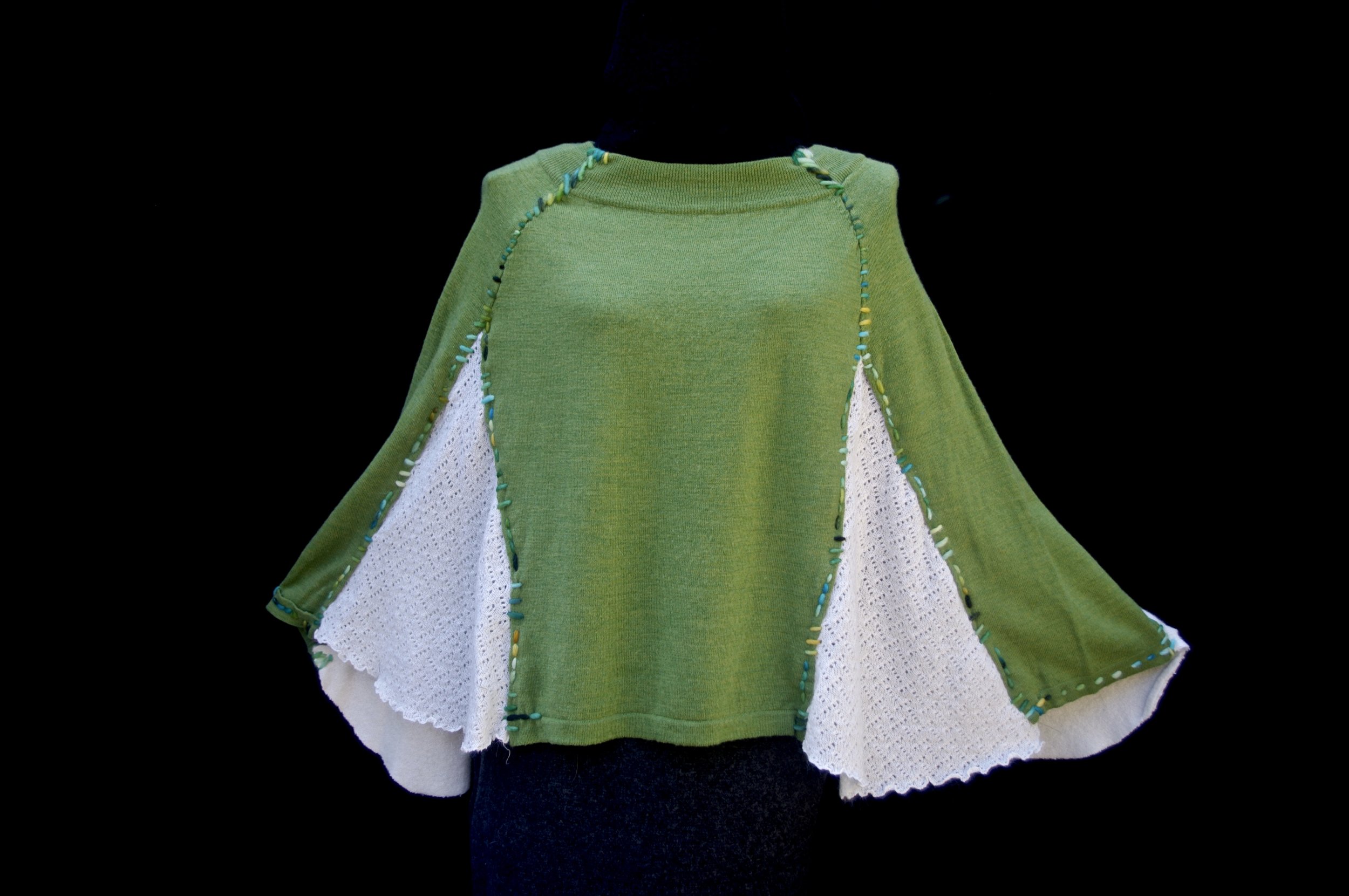 Handstitched poncho of upcycled cashmere.