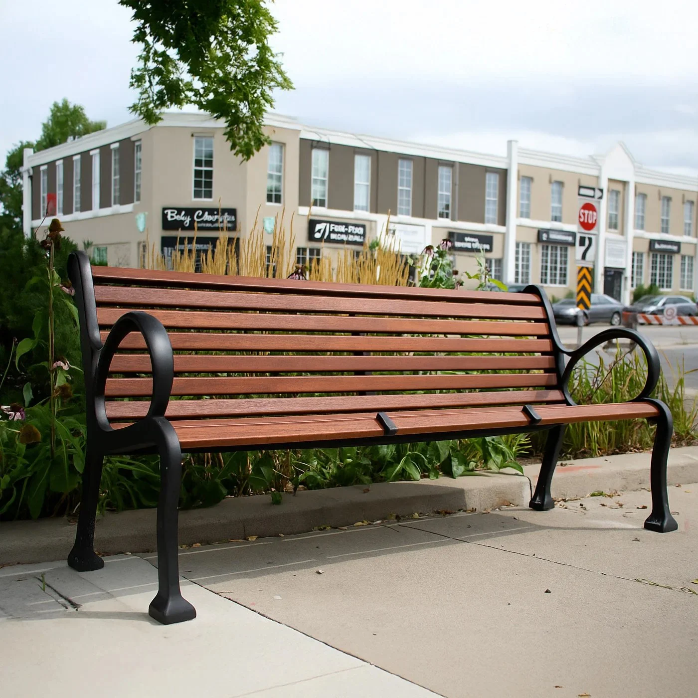 Traditional-style park bench featuring wood-grain slats and decorative black powder-coated aluminum armrests and legs.