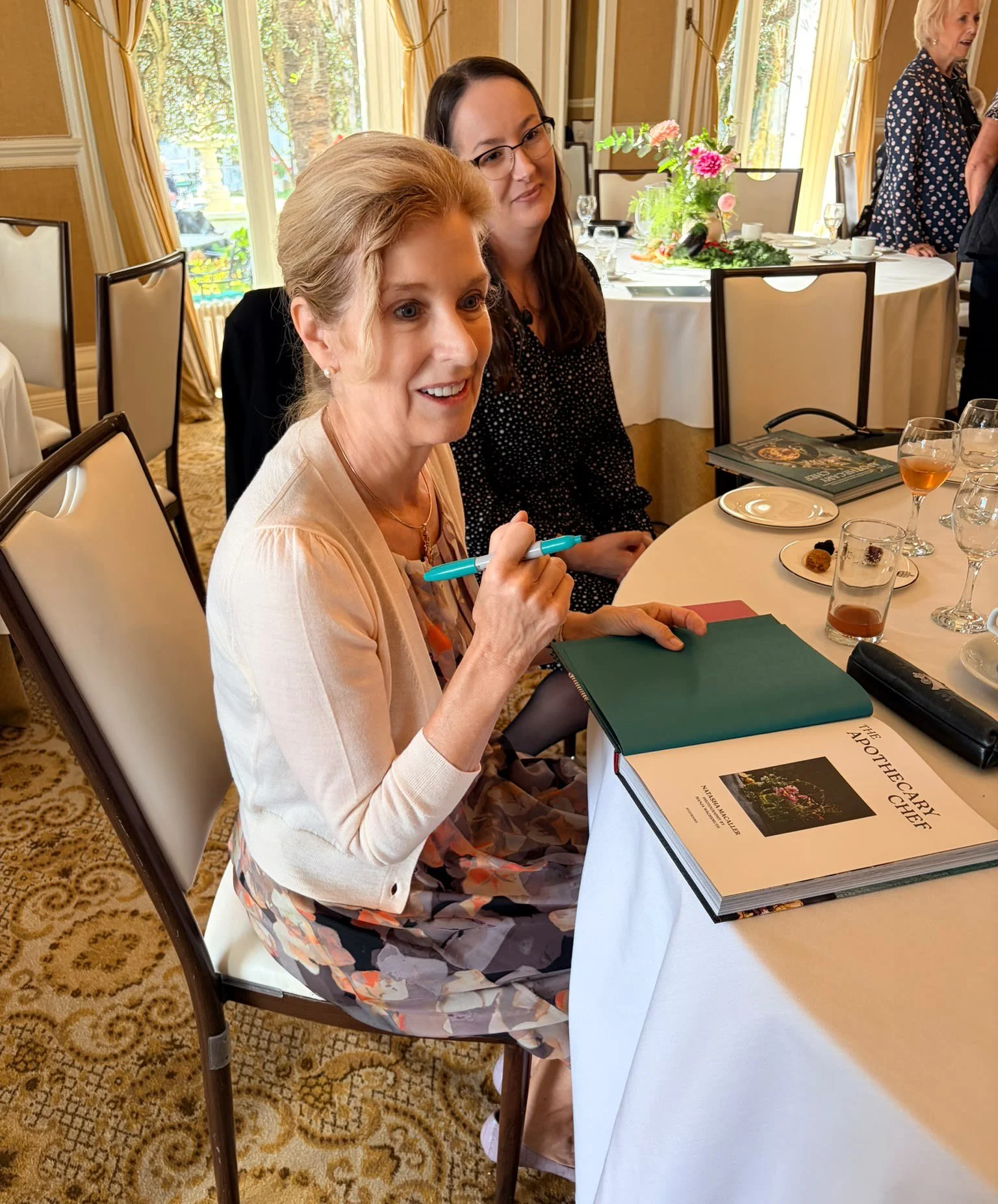 Natasha signing copies of "The Apothecary Chef" and chatting with guests.