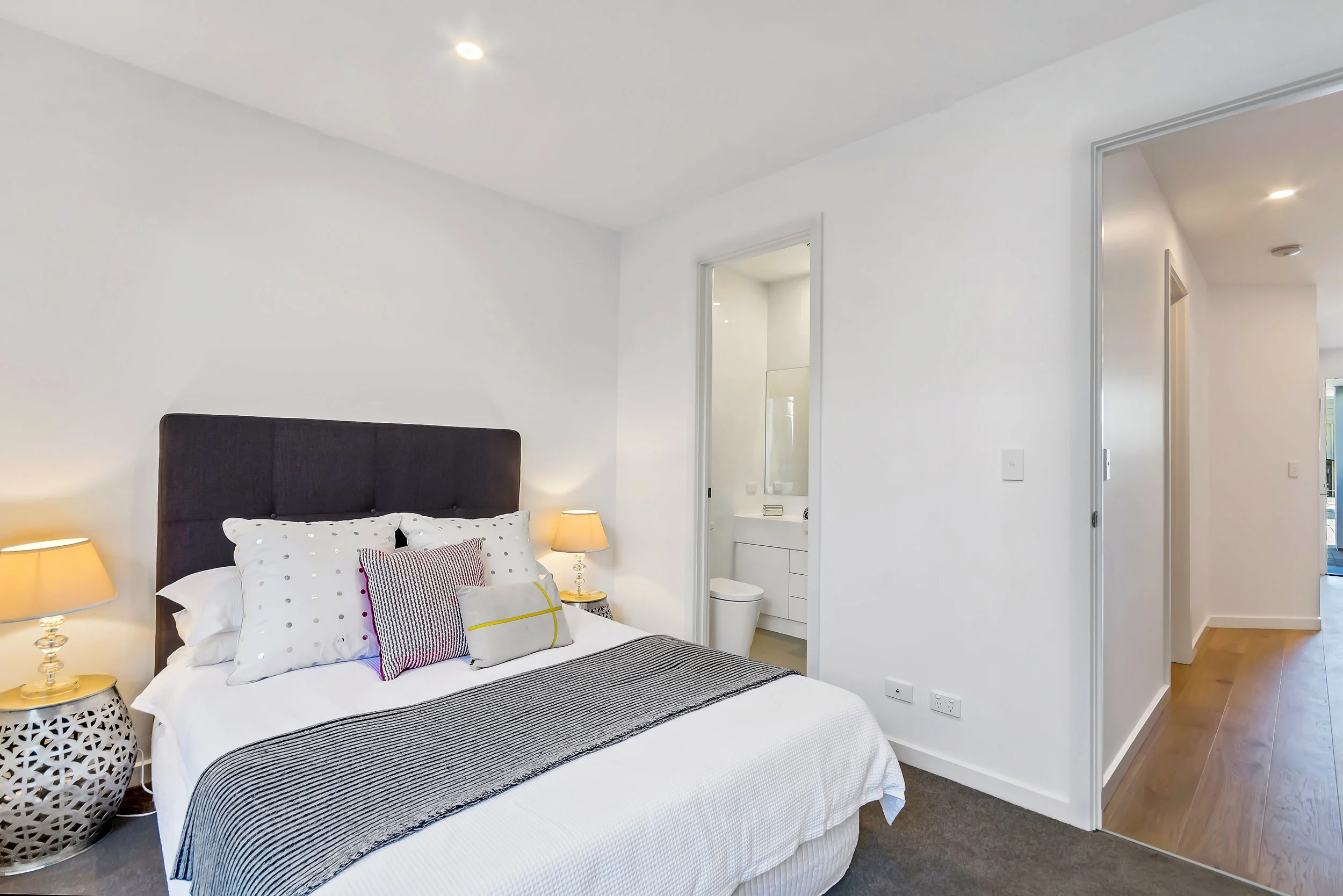 Bedroom 1 with floor to ceiling built-in robes, ensuite complete with Caesar stone and 2-pac vanity, opening to own private courtyard.
