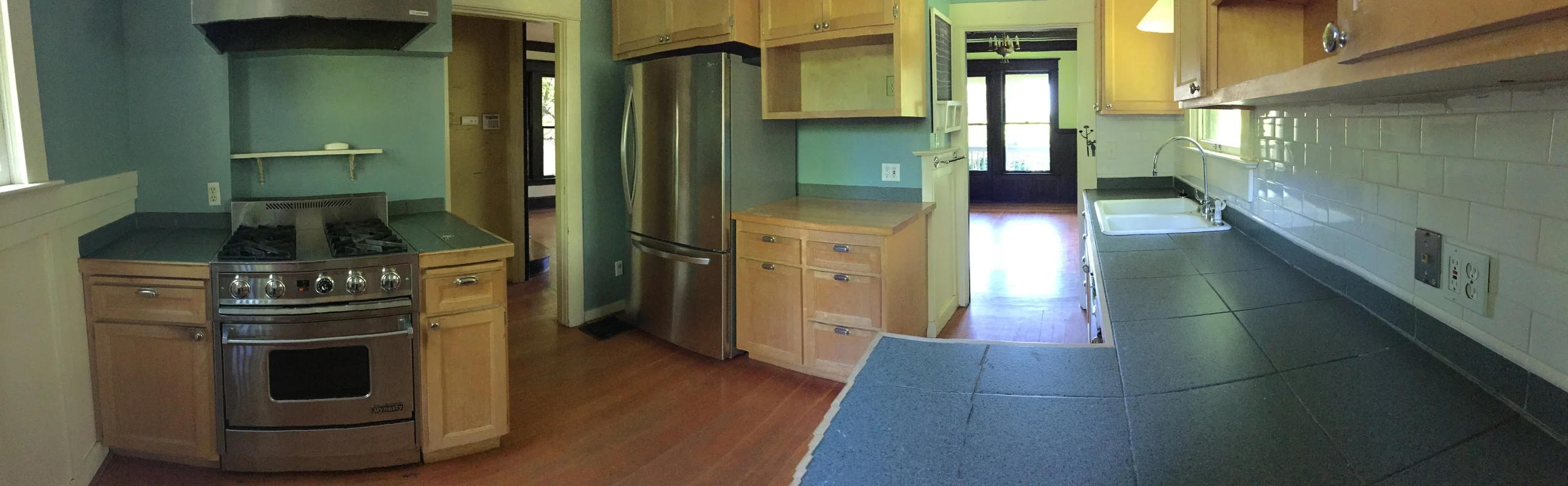 Kitchen with gas range and new refrigerator.