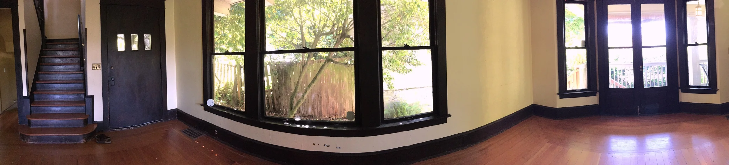 Living area panorama. Front door to the left, south-side windows, west doors to deck.