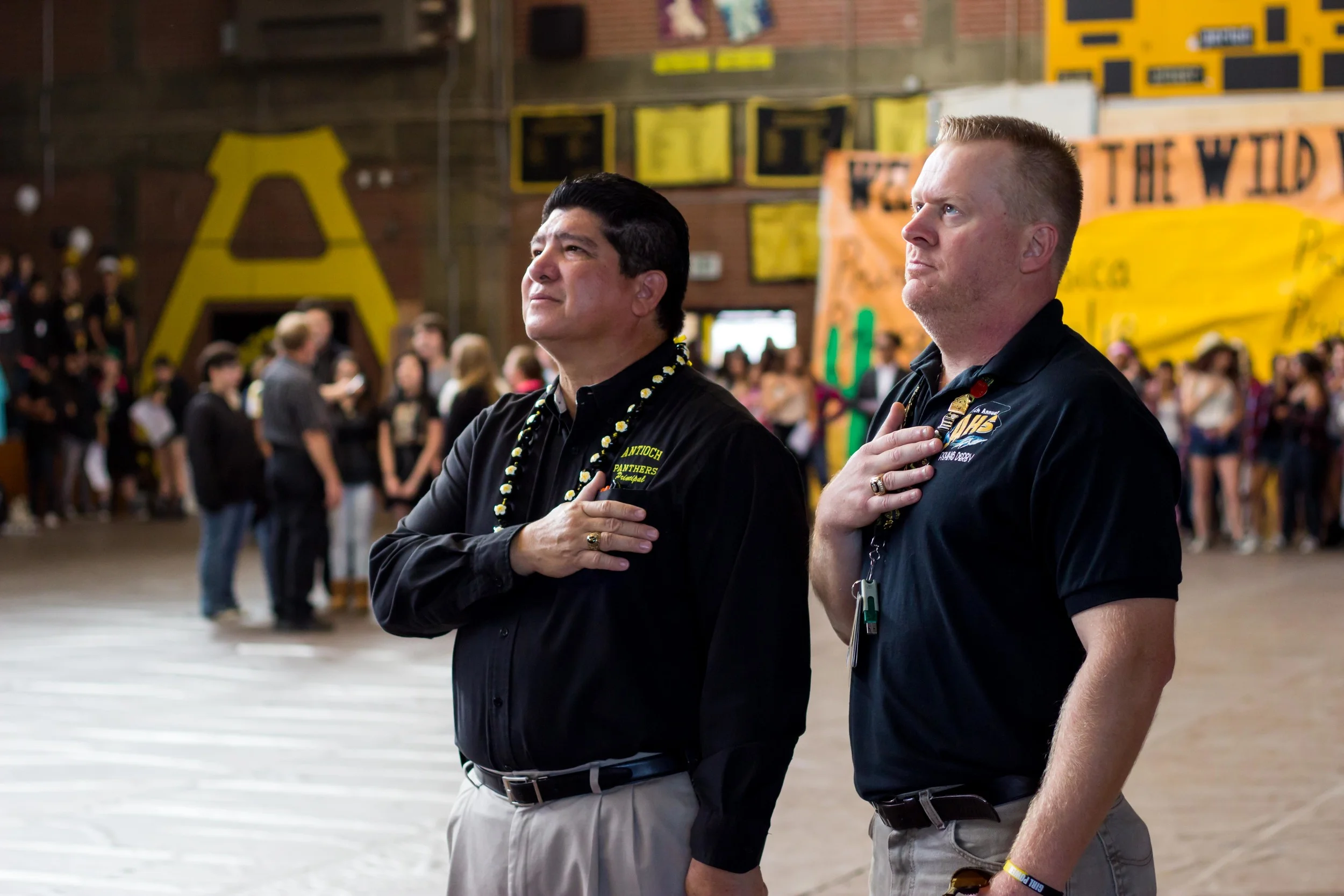 Mr. Mathews (right) with Principle Rocha (left) during the National Anthem at Antioch High's Class of 2015 Homecoming Rally.