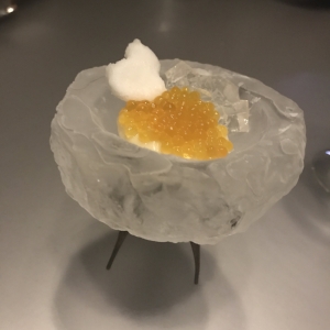 Roe, passion fruit sorbet, macadamia distillation, pineapple and kombu foam served in a hand-carved ice bowl.&nbsp;