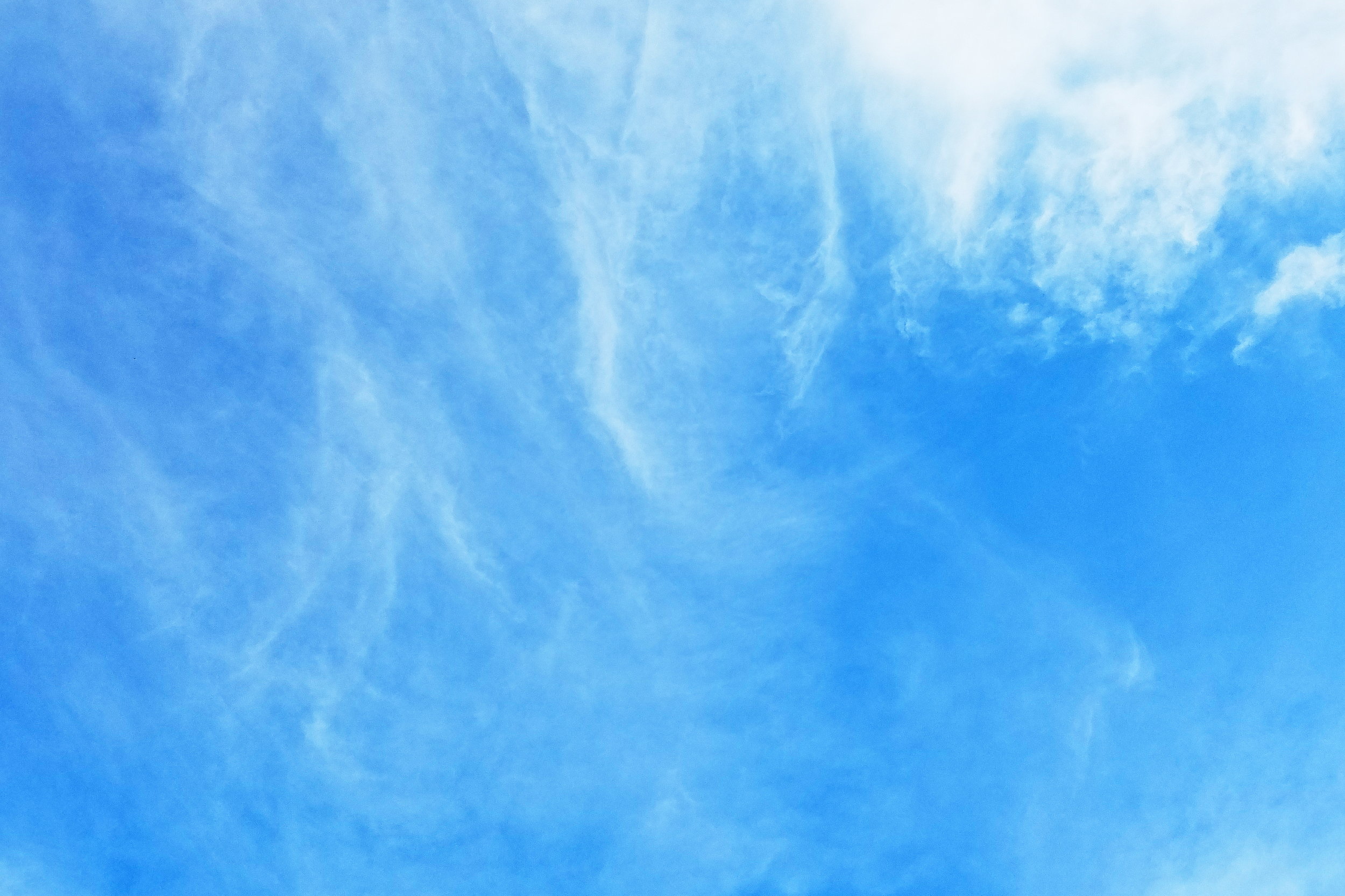 Wispy clouds and vibrant blue skies