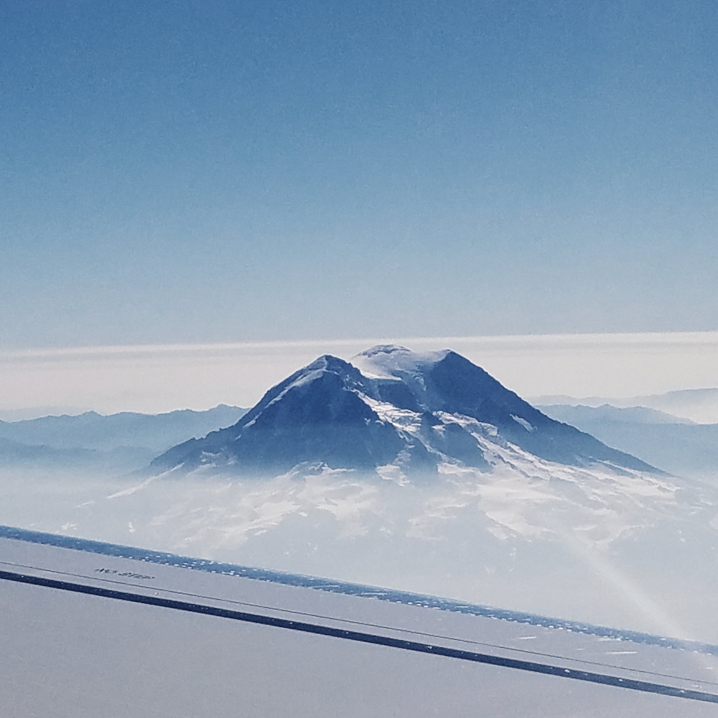 Looking down on smoke-shrouded Rainier from my flight south