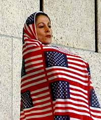 Shida Pegahia in a chador woven from small American flags, designed by Gita Kashabi.