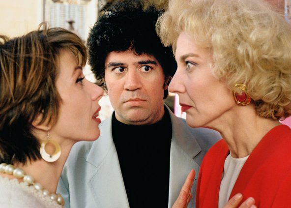 Almodóvar on set directing co-stars Victoria Abril and Marisa Paredes in High Heels .