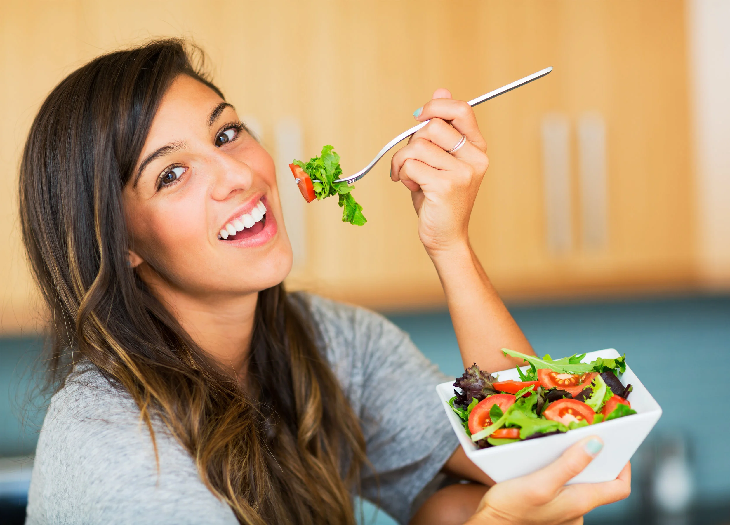 Healthy woman eating salad