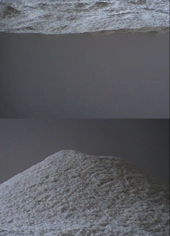 video still The split screen video shows the same video, one forward, the other in reverse. Extracting from one side to the other methodically and systematically, over and over.