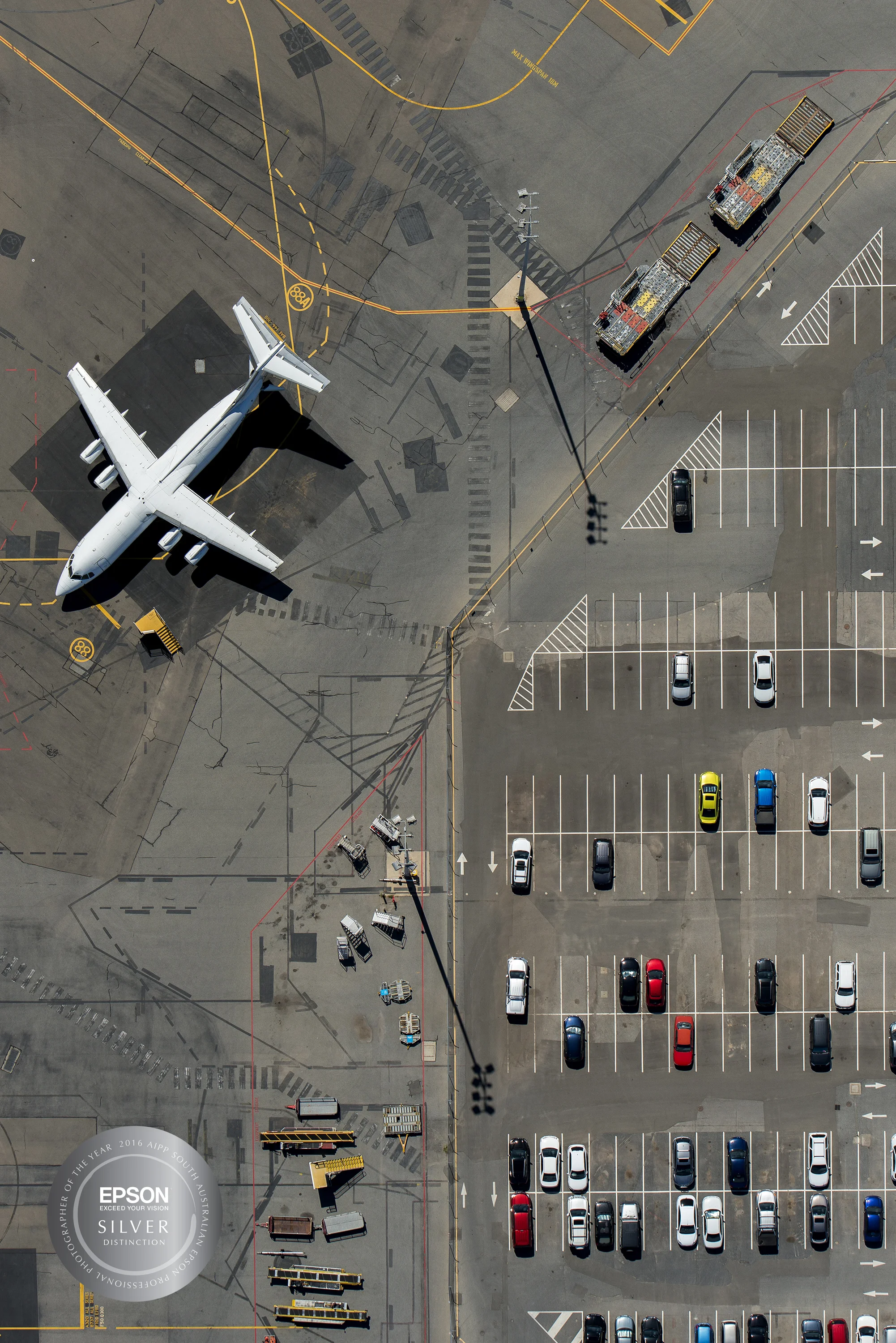 The long term car park at Adelaide Airport with a BAE146 aircraft. When flying at 500ft in a helicopter everything happens very fast below, you really trust your instincts for framing and subconsciously 'seeing' - this was captured during a charter to photograph the new solar installation on the roof of the Adelaide Airport carpark as well as various sites around the airport precinct for both Solgen and the airport . I really like the strong opposing shadows from the floodlights (and the cars that look like Matchbox toys!). Shot on a Nikon D800 and processed in Lightroom and Photoshop.
