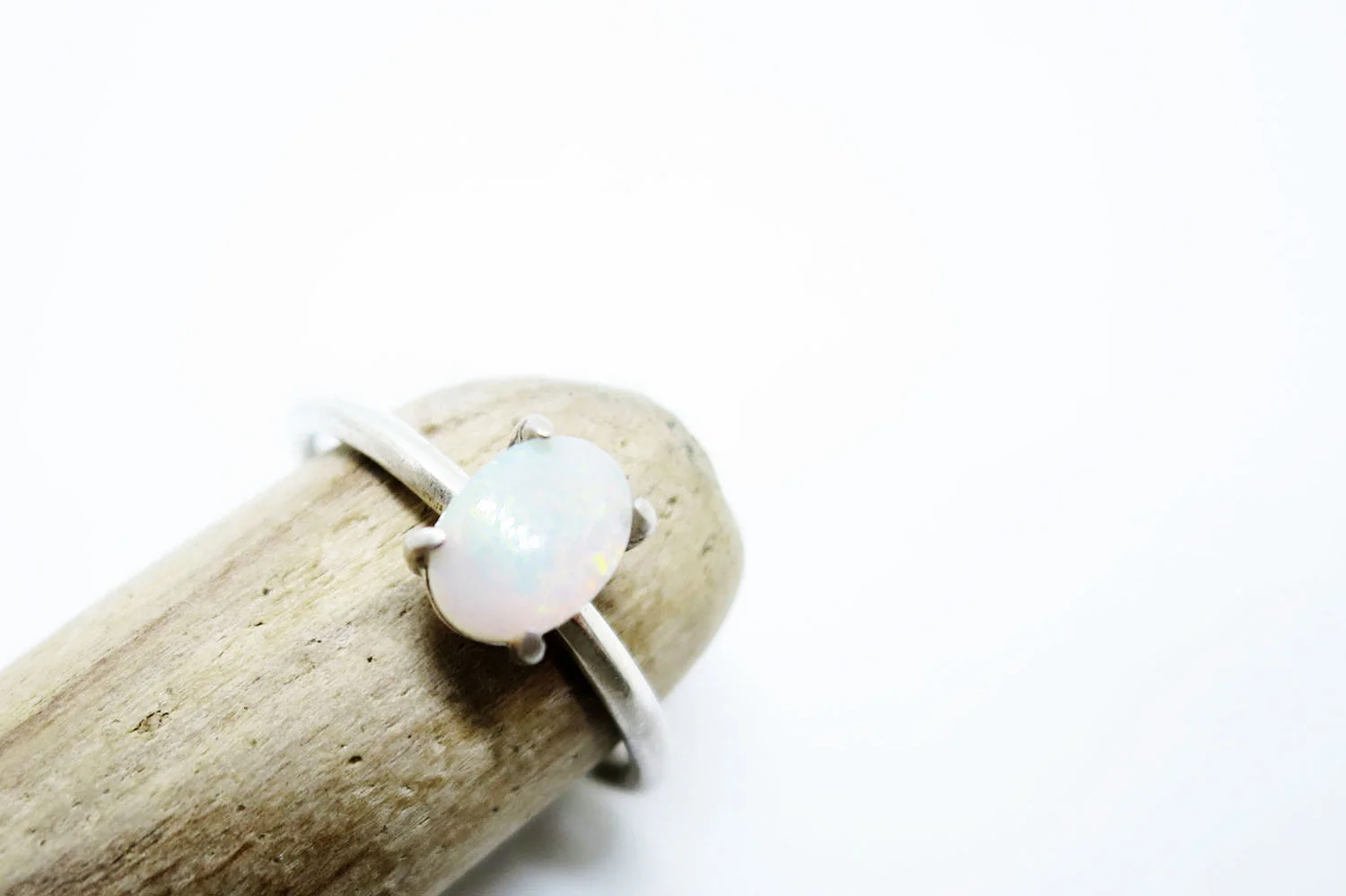 milky opal solitaire on wood.jpg
