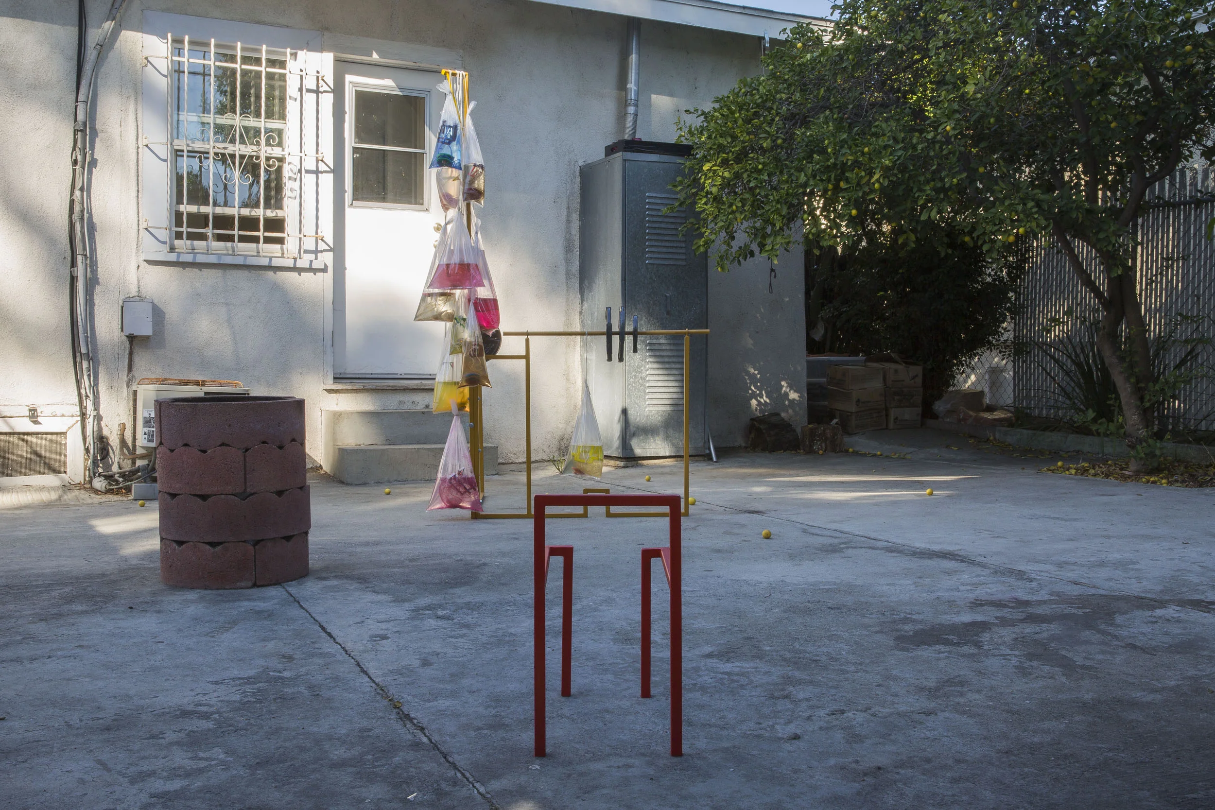 Hole #15. Orr Herz, Feather weight, 2015. Metal, basswood, yoyos, strings, weights, water, paint. Dimensions variable. At DIANA.