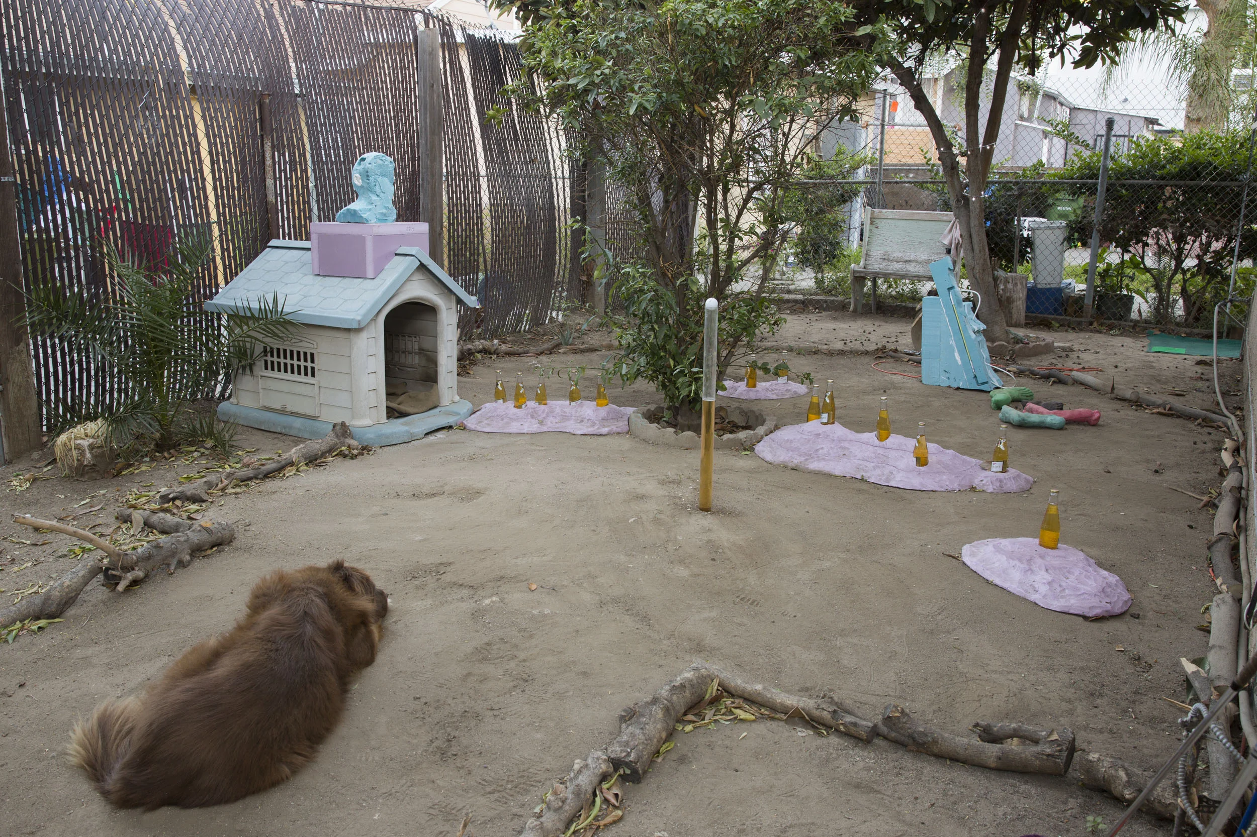 Hole #3. Anton Lieberman, Sick Odyssey, 2015. Foam, plastic, rubber, glue, paint, tape, neon, transformer, wire, branches, dog house, tree, concrete, dirt, bucket, golf balls, Miller High Life. Dimensions variable. At Outside Gallery.
