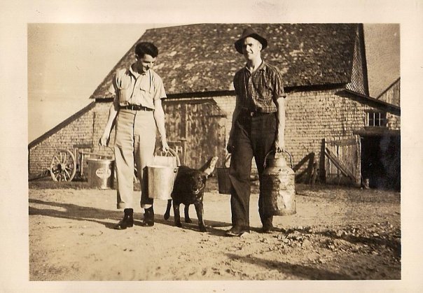 Dad (in hat) with a pal, looking entirely too happy and handsome to be doing farm chores.