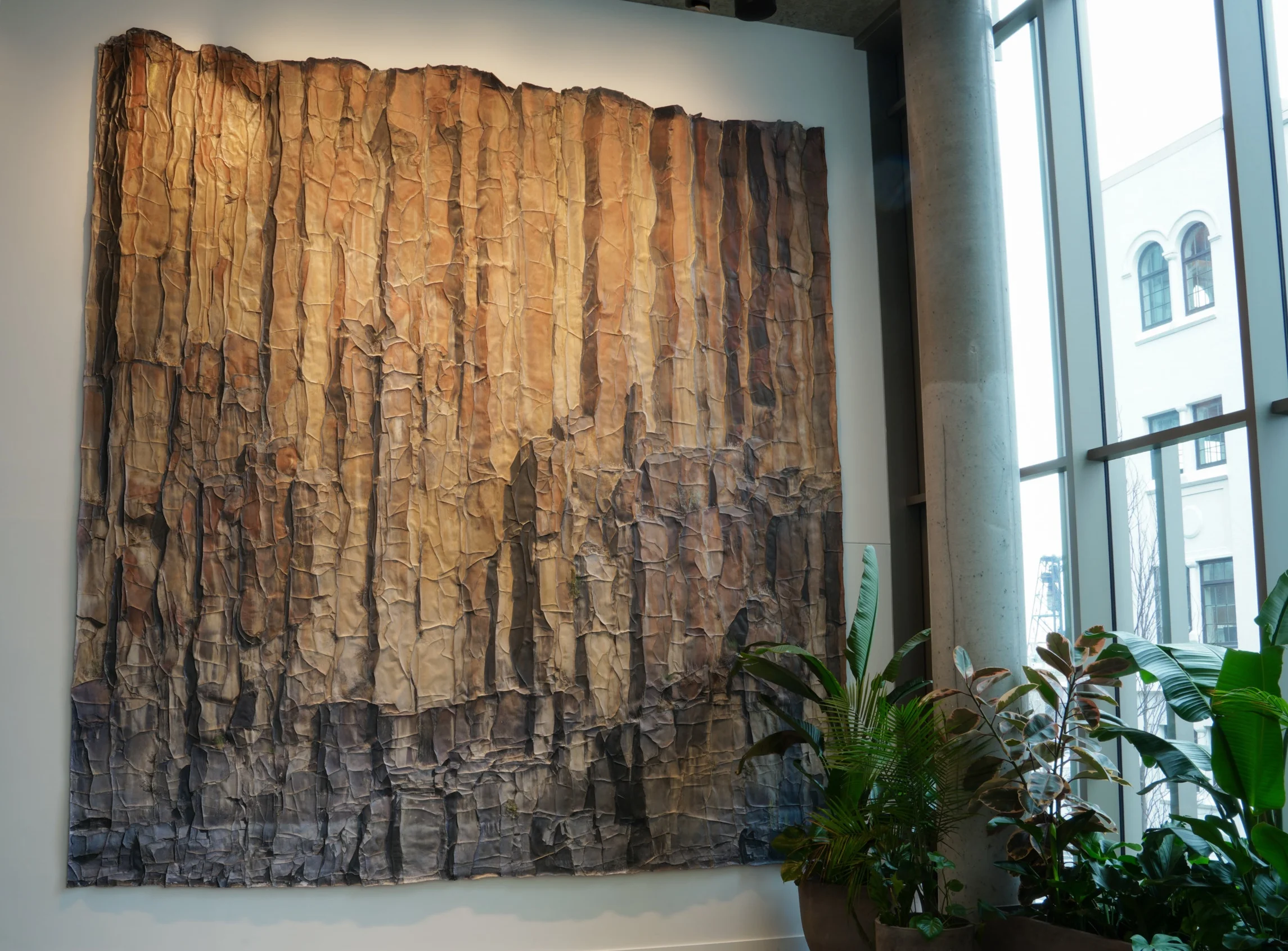 Over the course of millennia, the John Day River cut a deep canyon through central Oregon to reveal dramatic columnar basalt walls. Formed when massive volcanic flows cooled, contracted and cracked, these exposed surfaces record the slow unfolding of geologic time and the forces of nature they have witnessed. The wall was captured with high-resolution images that were printed, cut, laminated, reassembled and mounted at three-quarter scale of the original subject. This large-scale photographic sculpture both interprets the story and dimension of these raw surfaces and transmits the profound wonder of experiencing our natural world directly.
