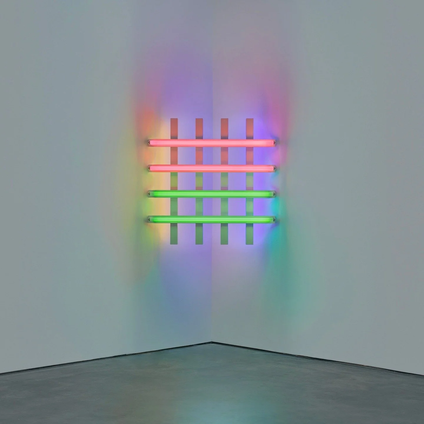 A new show of neon grids by Dan Flavin has just opened at David Zwirner on W 20th Street. Suspended in the corners of the gallery space, the grids are lattices of neon tubes casting green, pink, yellow and blue light throughout the gallery. The posit
