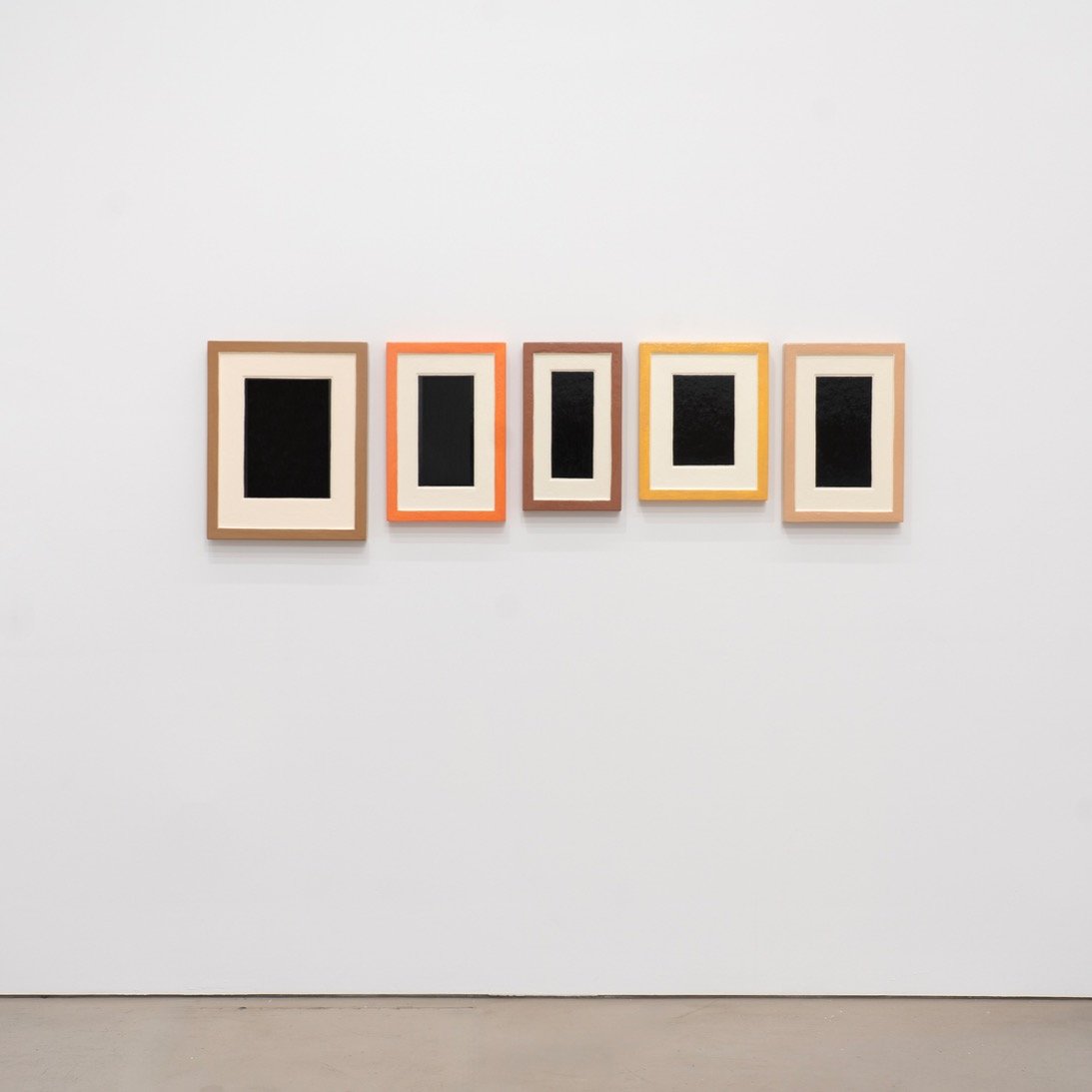 A Moment in Time: Plaster Surrogates, 1991-1993 at Petzel Gallery in Chelsea presents works from Allan McCollum's Plaster Surrogates series. Each work presents a cluster of framed black paintings with cream matting. Frame, mat and ambiguous picture p