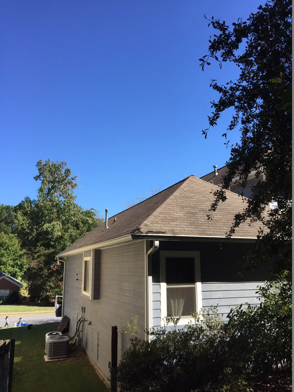 BEFORE- This the side of the house and rear -- looking right at the master bedroom and bathroom window. 