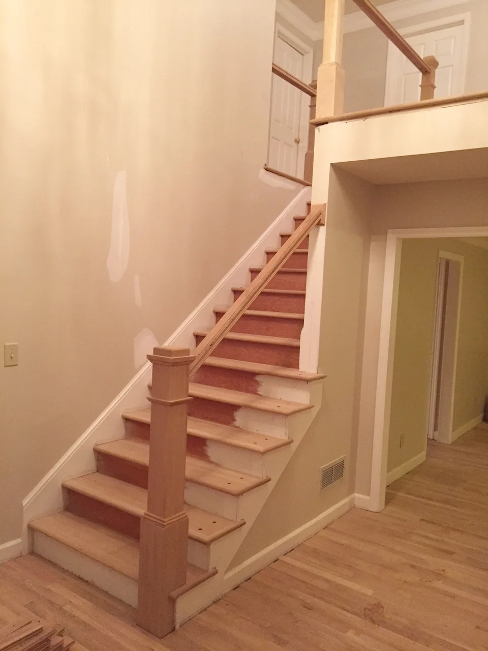 The old newel post was just too small for this tall and long entryway. By increasing the scale and replacing the treads with beautiful hardwoods, the staircase becomes a focal point not just a means of transportation.