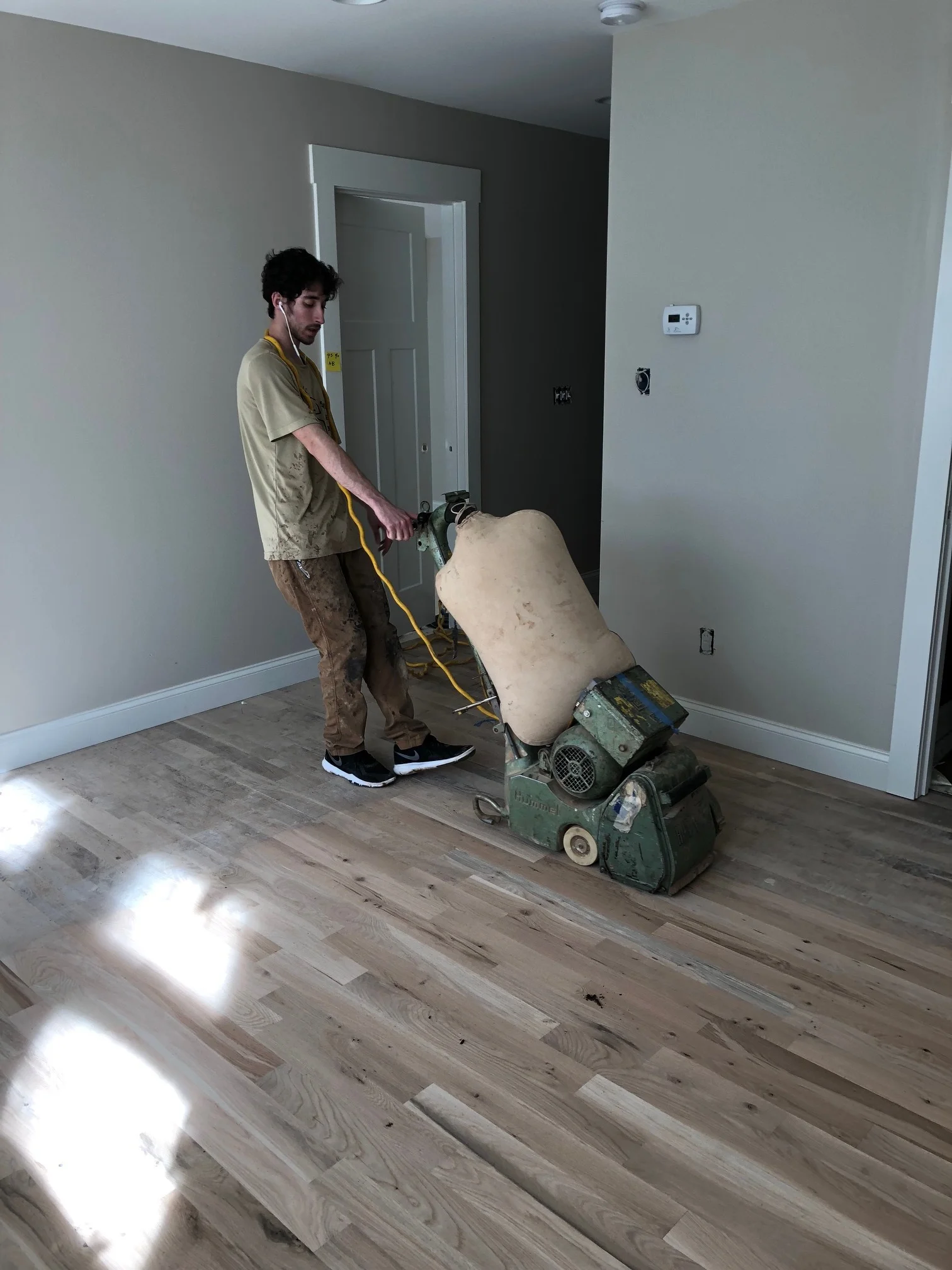 Sanding the floors at the Kitchen house.