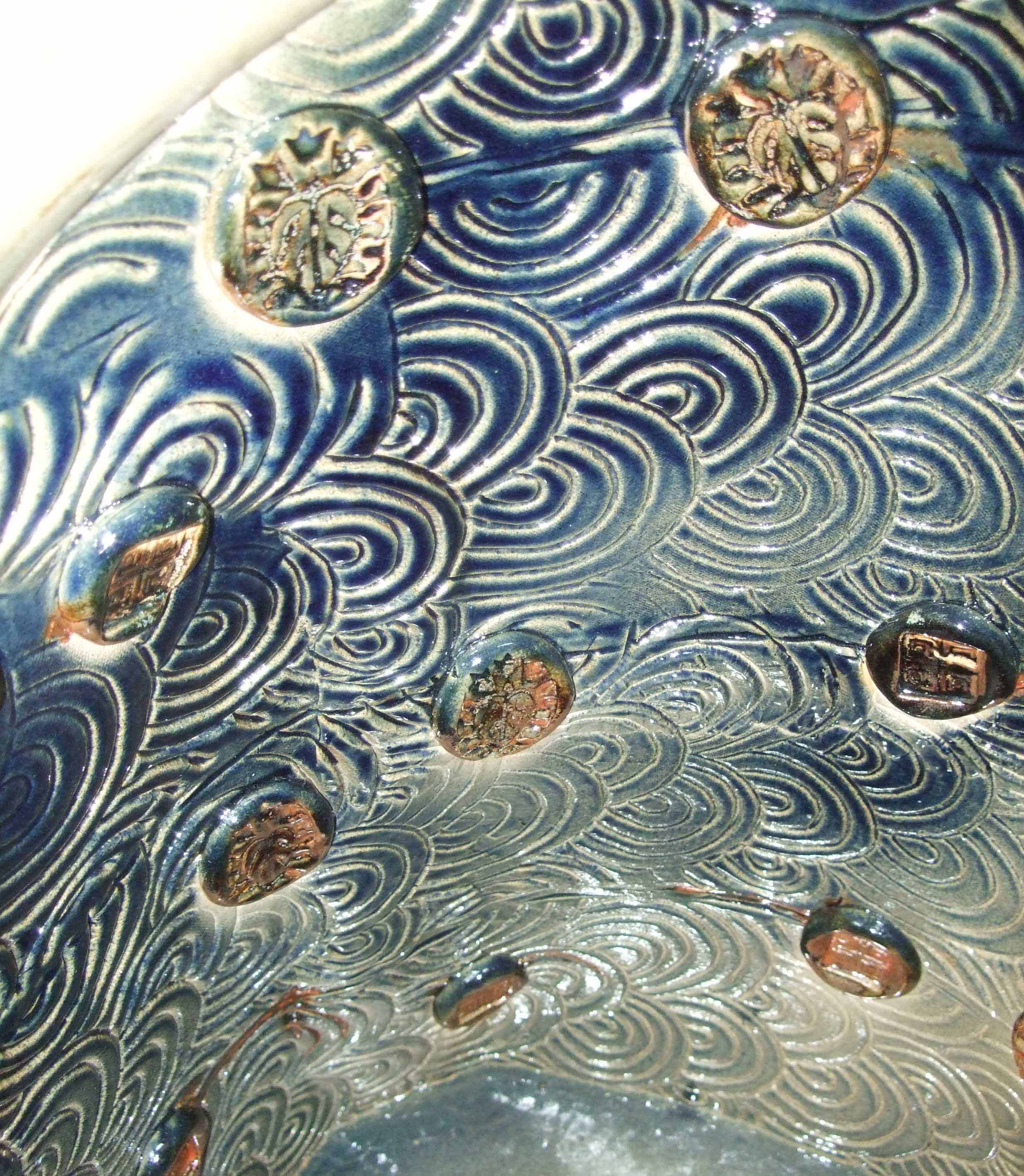 Inside this piece is a large expanse of imaginary water into which I have thrown pebbles, the ripples swallow them as they drop into the deep blue following each other to an uncertain depth.