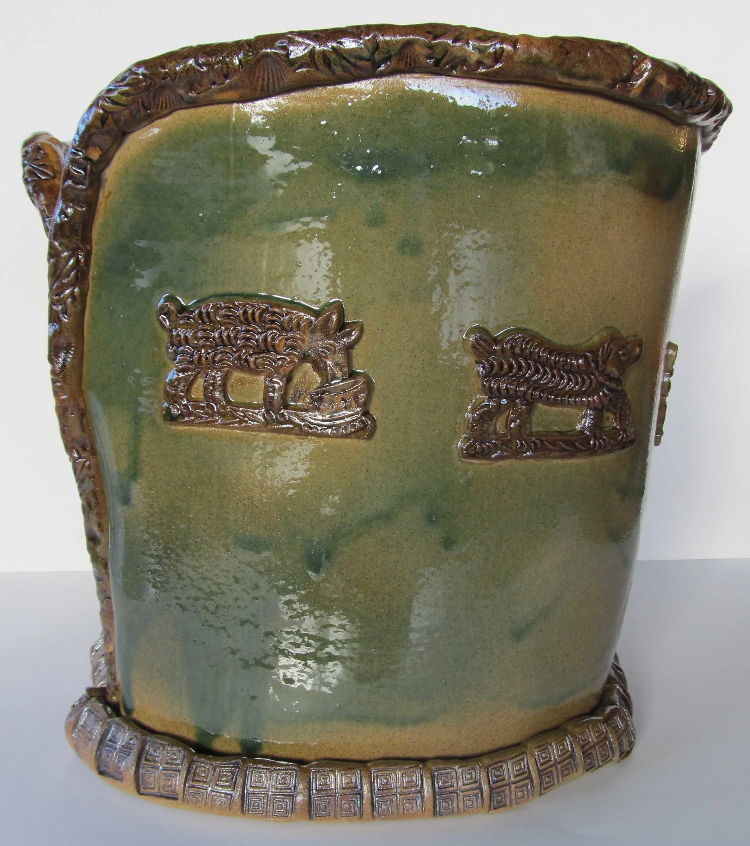  The softly moving “piped edge” punctuates the surface and finishes this tall form binding these glass green walls together. The walls are decorated with more details, printed to&nbsp;make a&nbsp;clay surface and&nbsp;added to it in a process similar