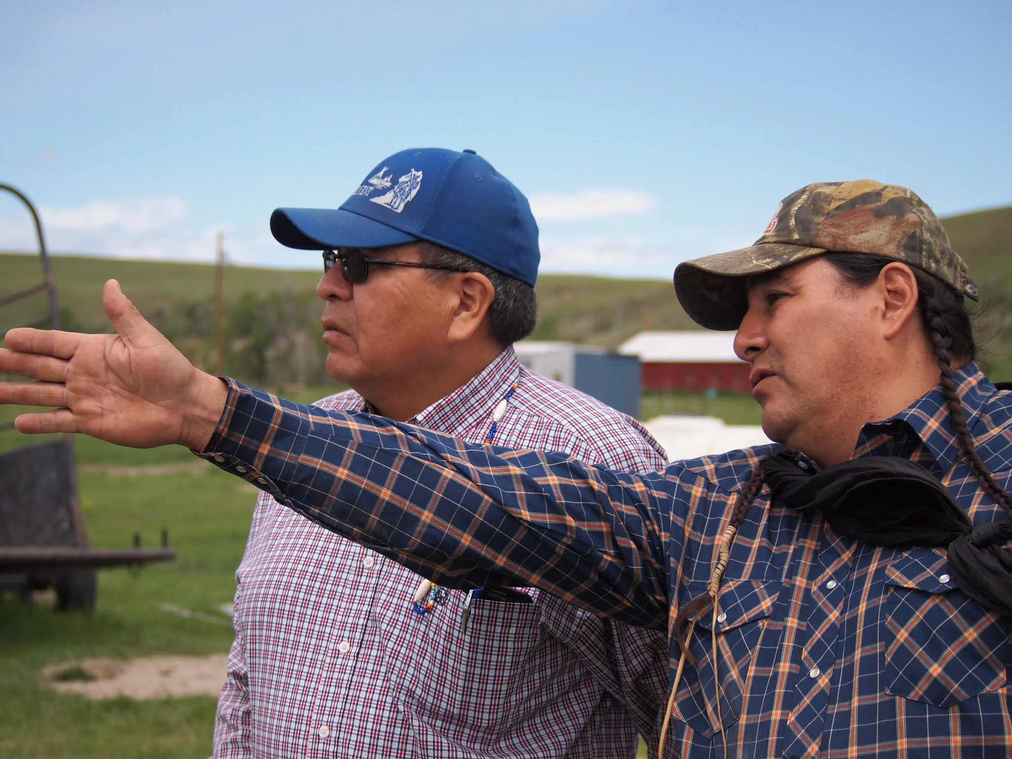 Winston Bruised Head (left) speaks with one of the bison ranchers