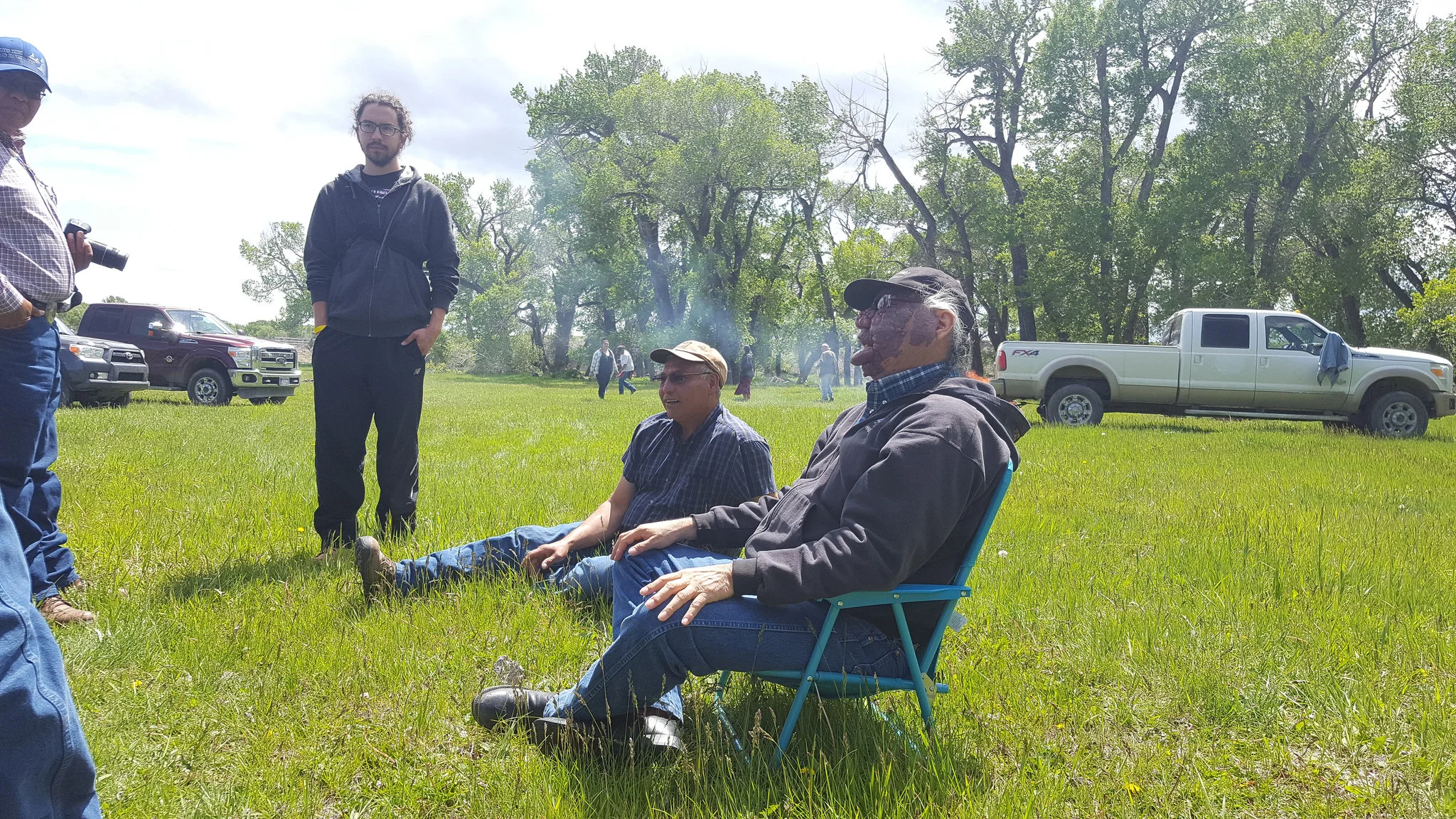 Mike Bruised Head (right) talks to the group before lunch