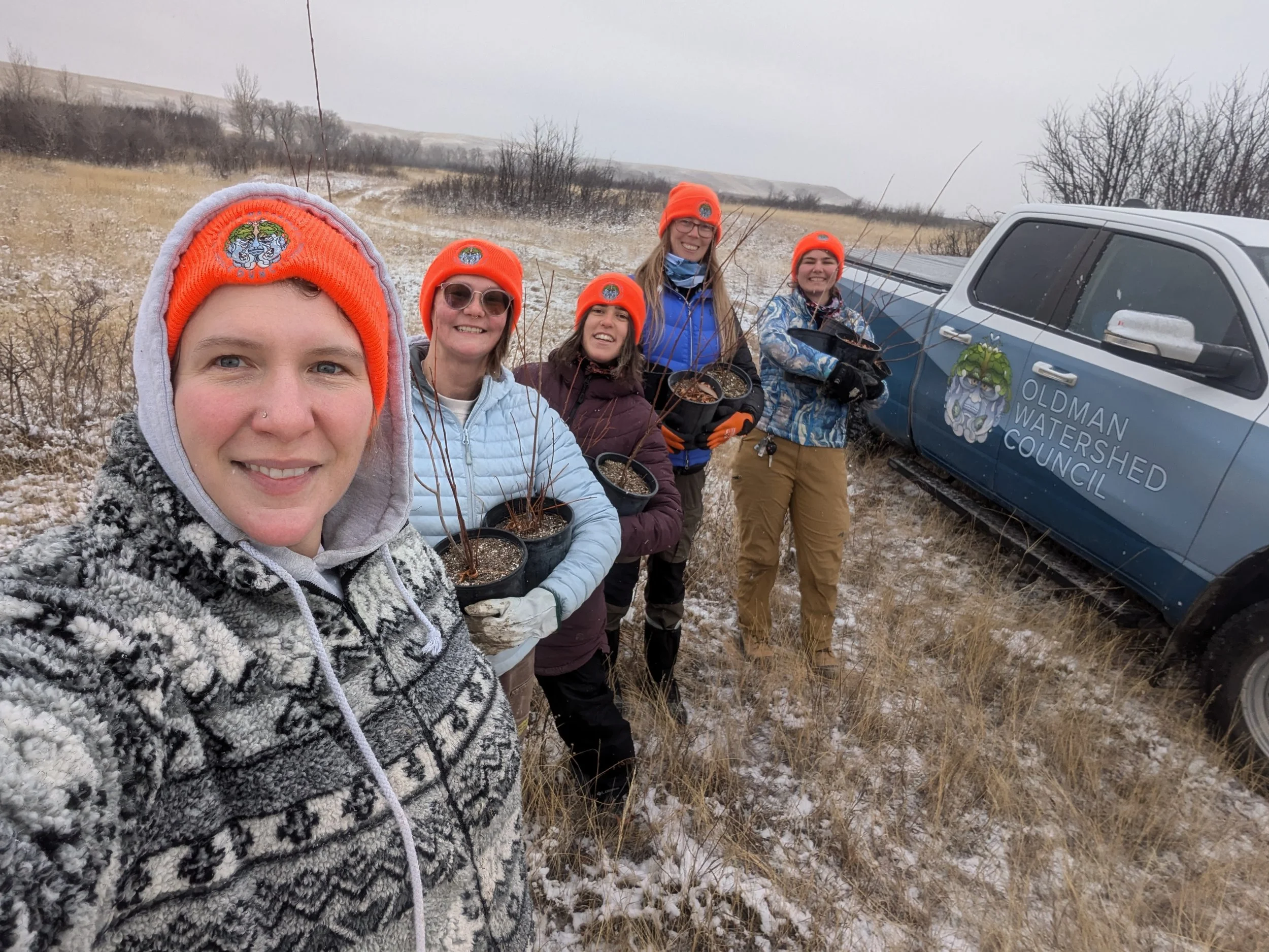  November 2024. Last planting day of the year (and the ground was more than a little frozen at this point). We’re down in the coulees of the Belly River, and our planting site was right on the shore. This is a great shot of the 2024 OWC field team: K