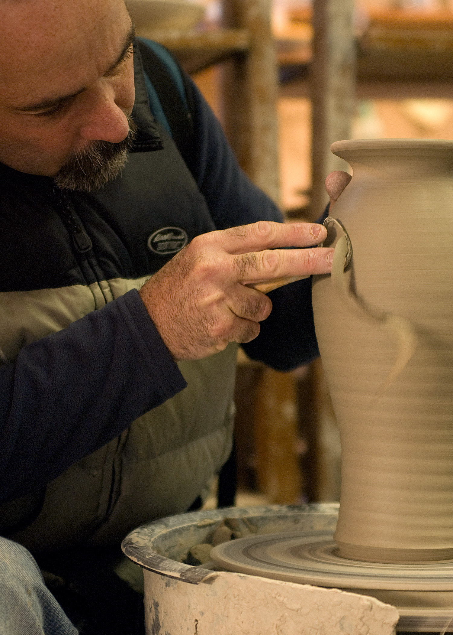 Putting finishing touches on a vase.