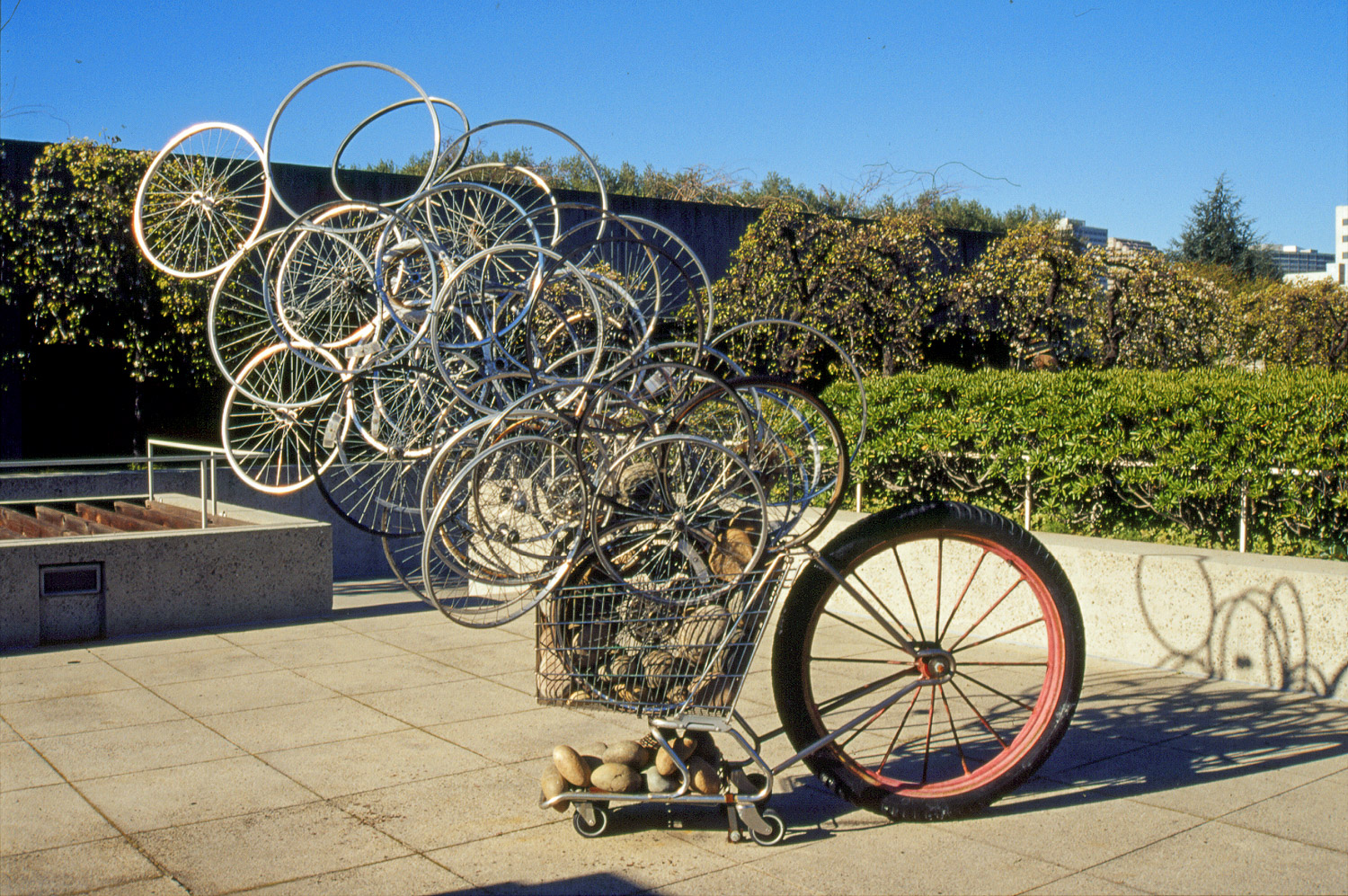 CARTWHEELS . 2002-2010 Oakland Museum of CA., Sculpture Garden. Multiple exhibitions including Napa Valley Museum 2011. Salvaged shopping cart, bike wheels, large farm cart wheel, river rocks.