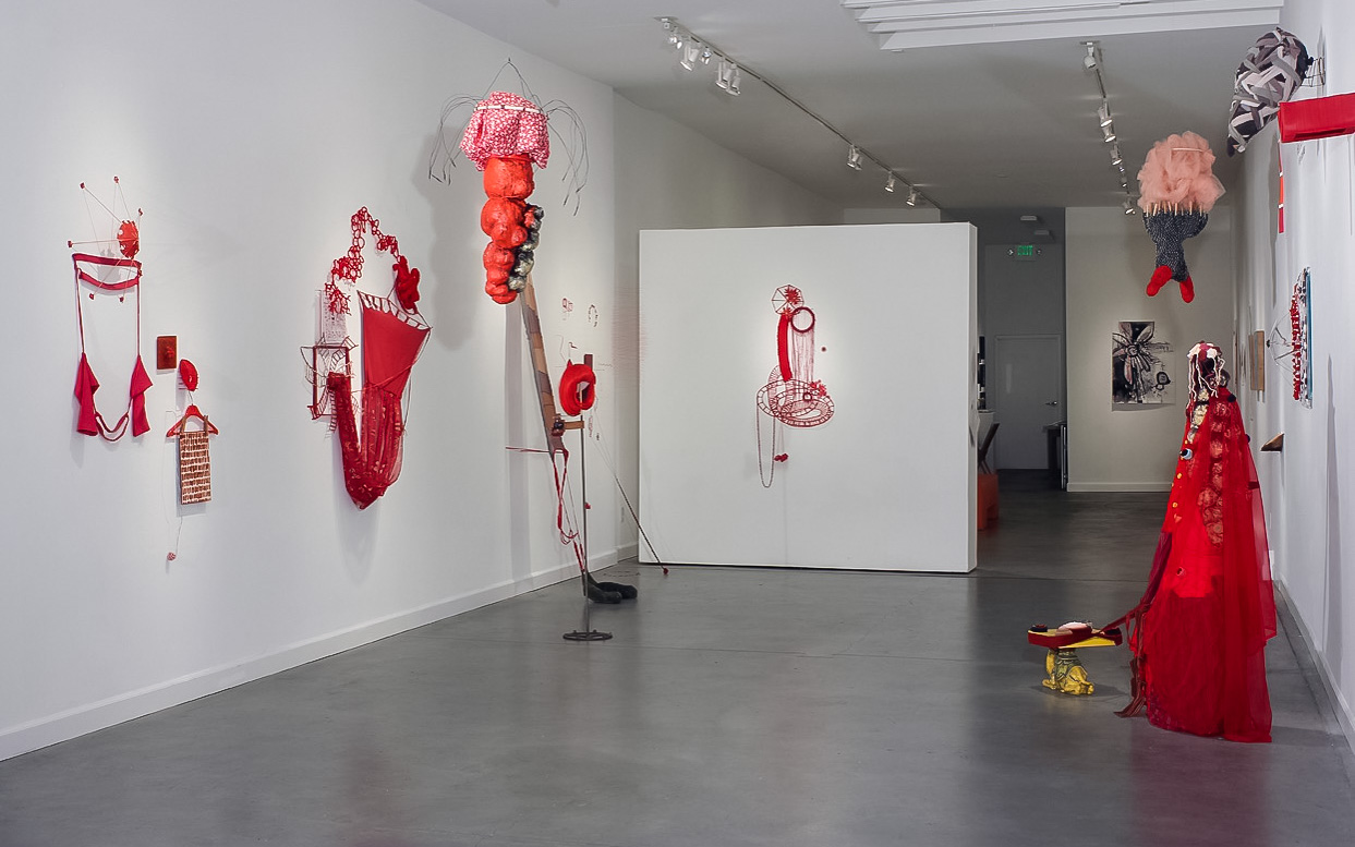 “Red in the Interlude” fabric, found objects, thread, wire