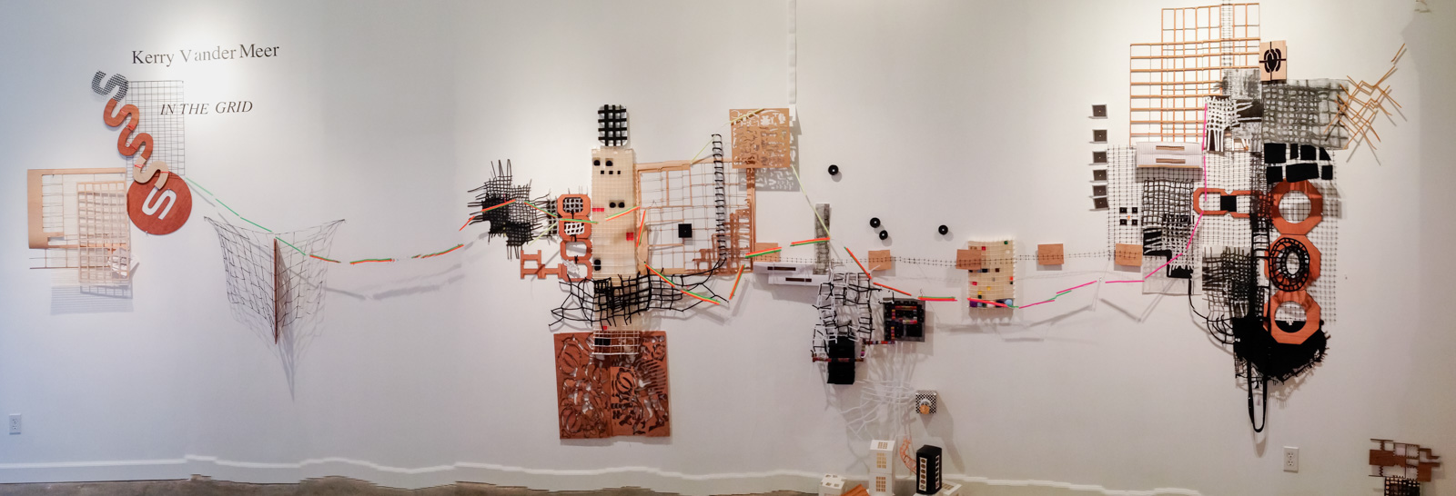 “In the Grid” Found objects, wood, fabric, wire, straws, paper, plastic