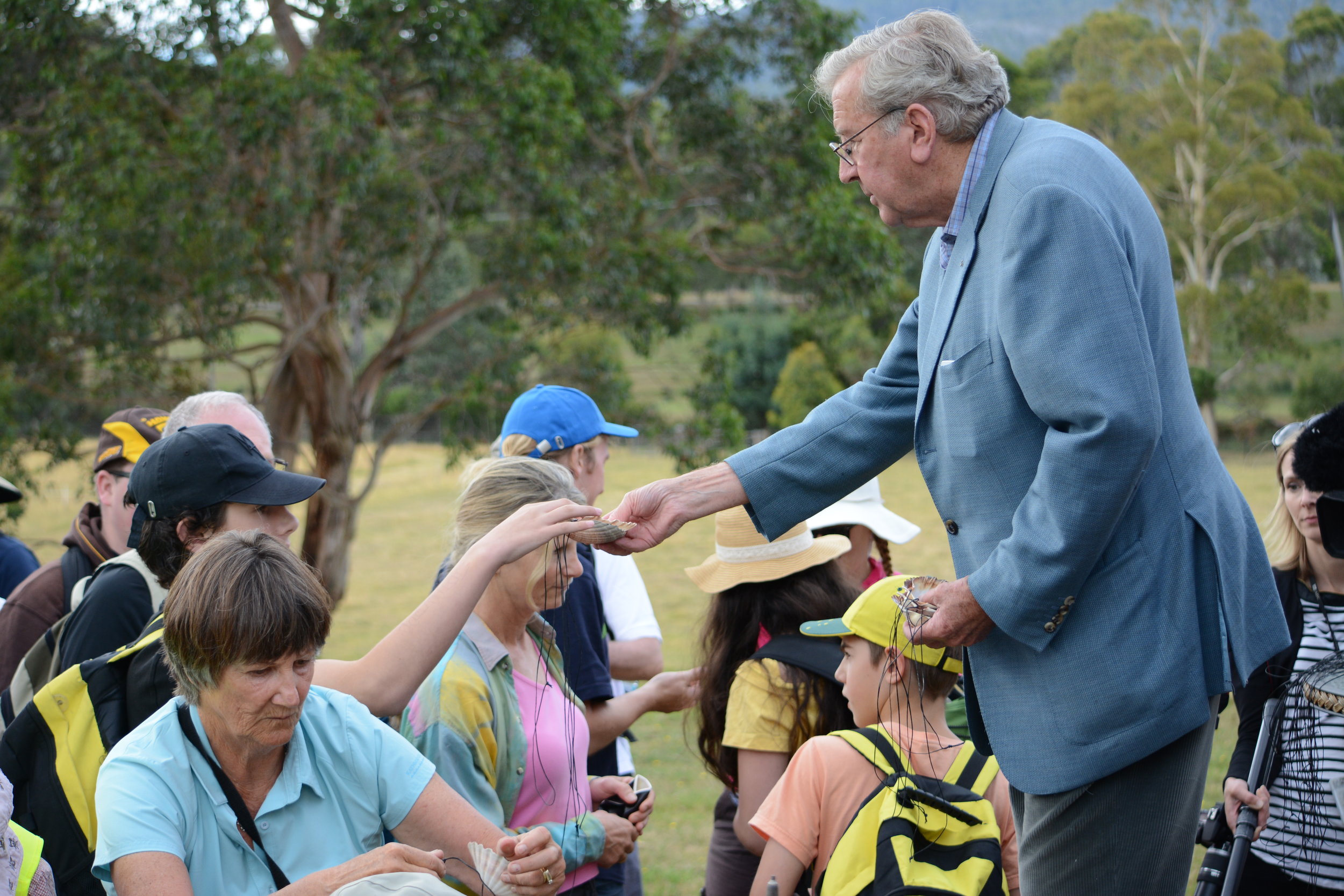 Way to St James_Fr Michael Tate handing out shells_1.JPG