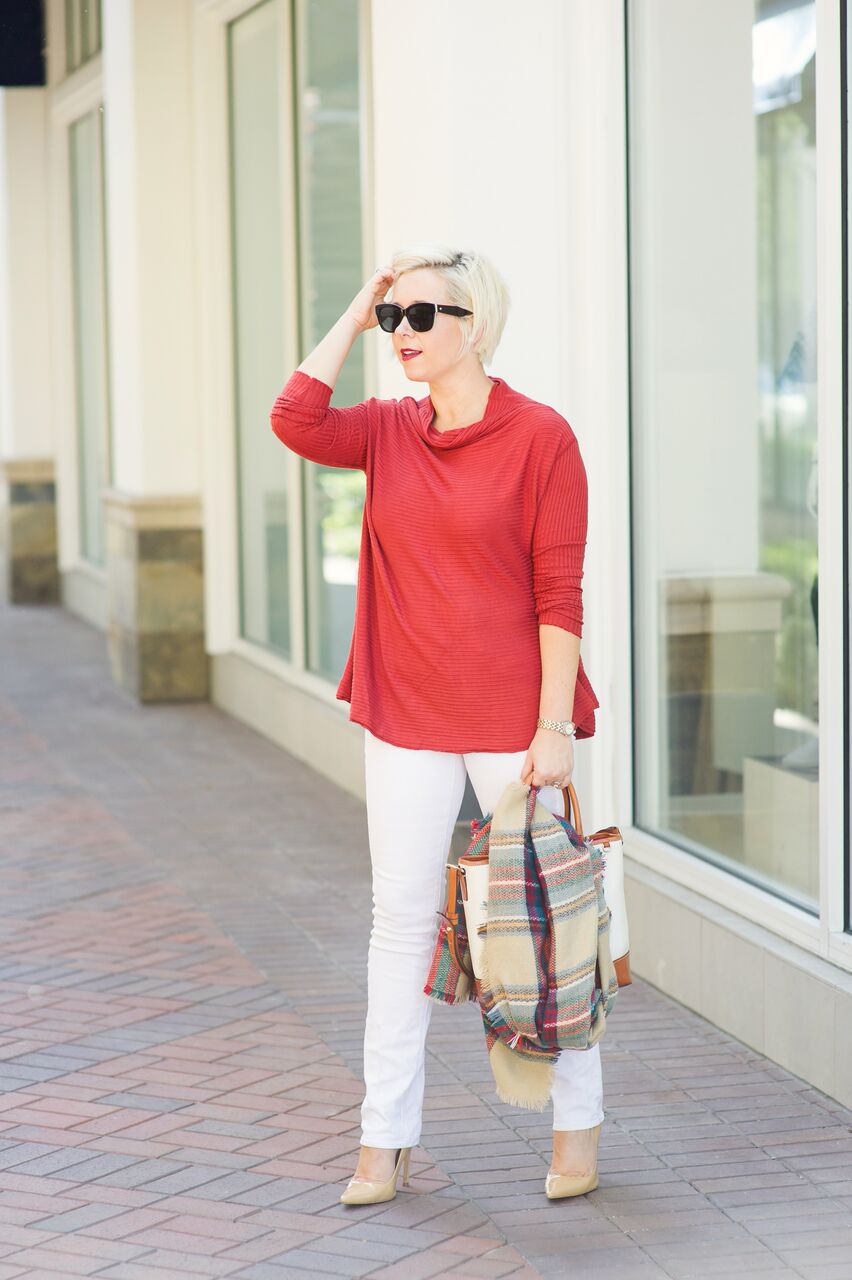  Orange sweater paired with white skinny jeans and plaid blanket scarf 