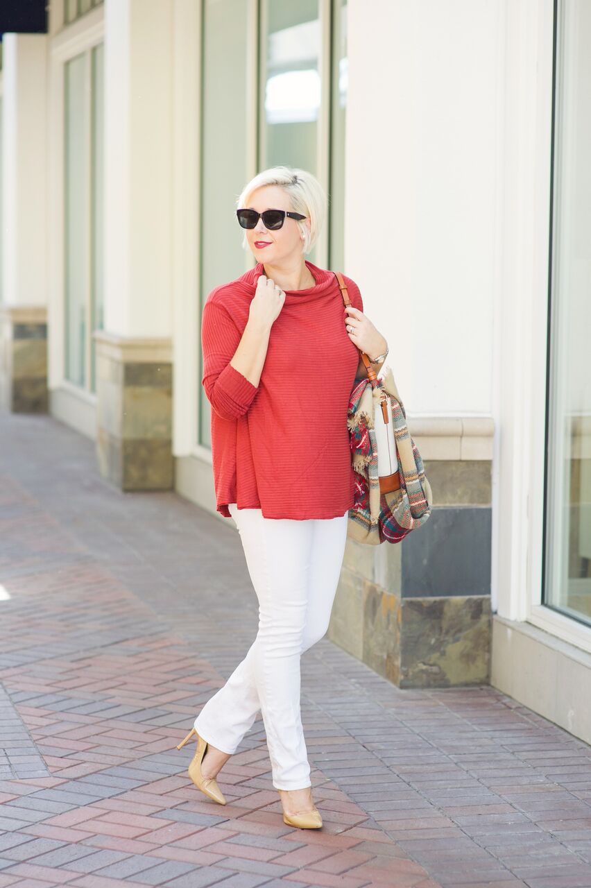  casual holiday look with orange turtleneck top and white skinny jeans 