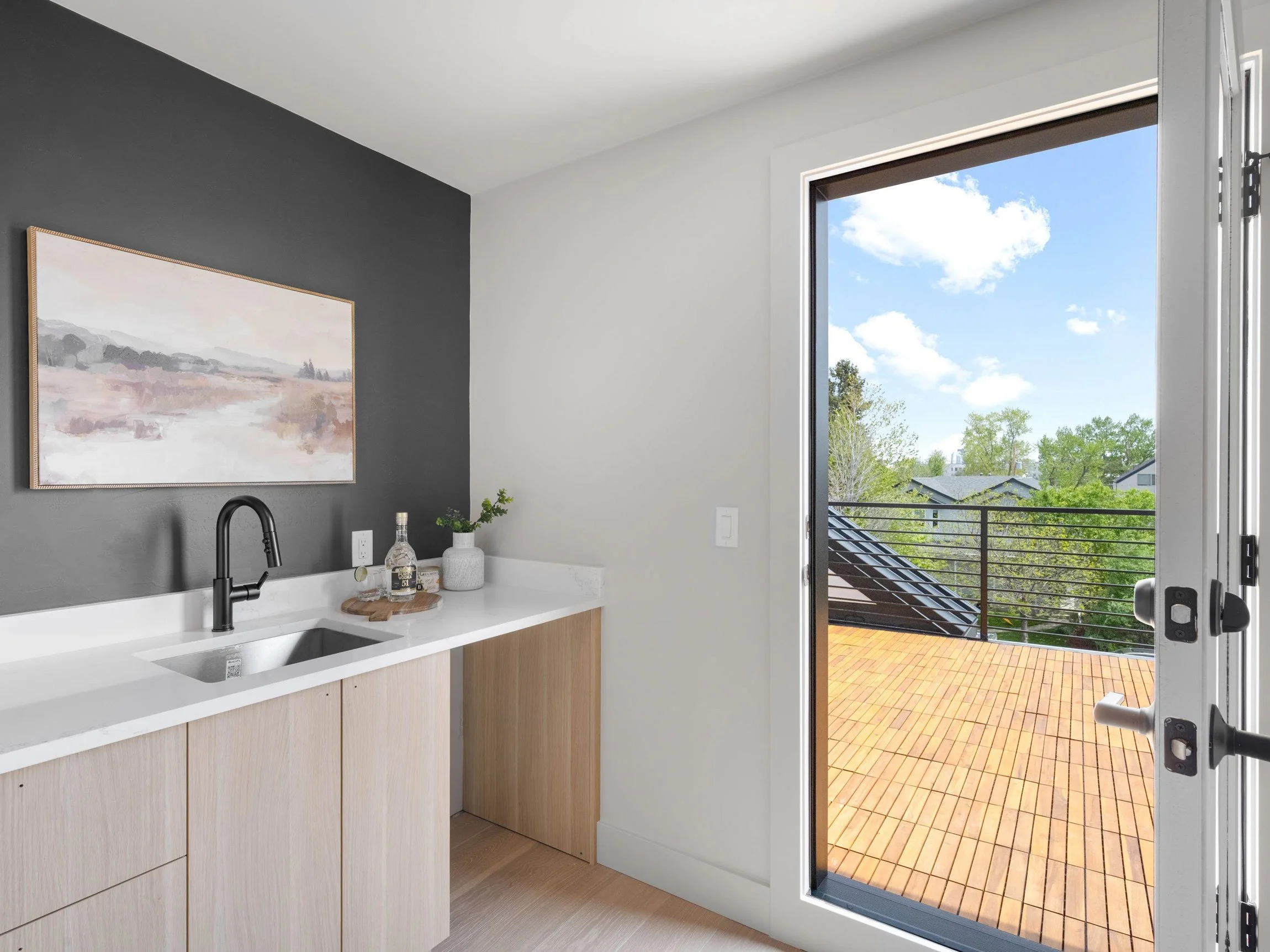 Built-in wet bar leading directly to a rooftop deck in a modern Denver custom home, designed for effortless indoor-outdoor entertaining.