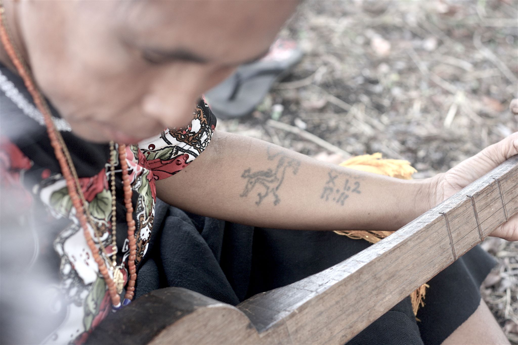 Like many men and women of her generation, Ata Ratu has traditional tattoos depicting marapu spirits and mysterious numbers and letters. Photo by Joseph Lamont.