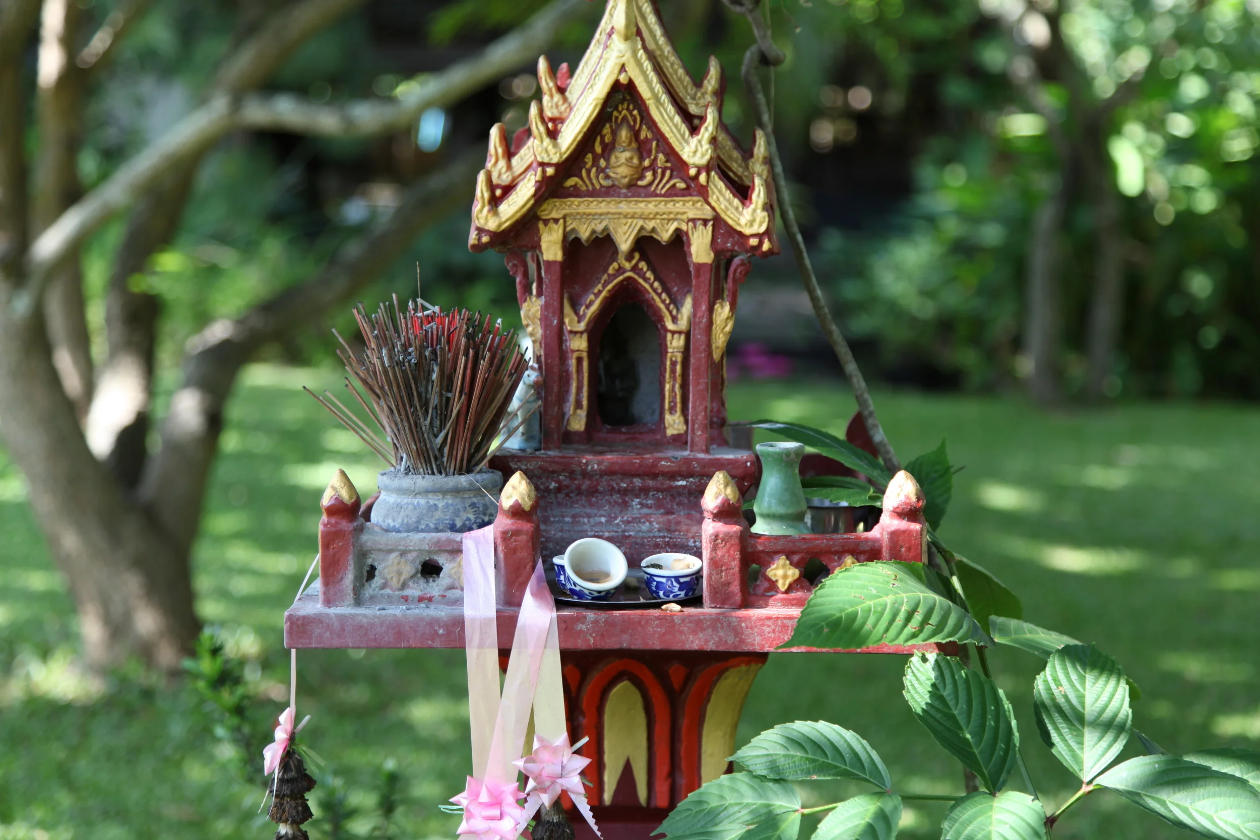 Spirit house at Baan Hom. The spirit house is a house for the spirits to live in. In Christopher's words "Thais are afraid of having the wrong relationship with the spirits. The spirits are everywhere and providing a house for the spirits who already live on the land where you live is a priority, more important even than building your own house.You must be able to say to the spirits, “Look, here’s an even more beautiful house for you. Here’s a beautiful palace complete with these gifts, and in exchange please allow us to share this space with you for the time being.” What a beautiful and considerate concept. I love Thailand for that. I loved seeing them all over Thailand. They are so beautiful. They are outside of houses , businesses, shrines and temples. They are maintained just as an alter would be maintained. Water ,food, incense (and sometimes a Red Bull) are offered everyday to the spirit houses.