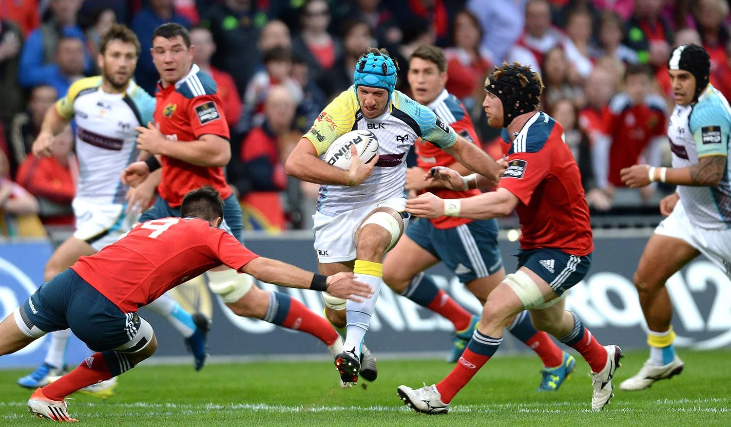 Justin Tipuric of Ospreys is tackled by Conor Murray and Sean Dougall of Munster